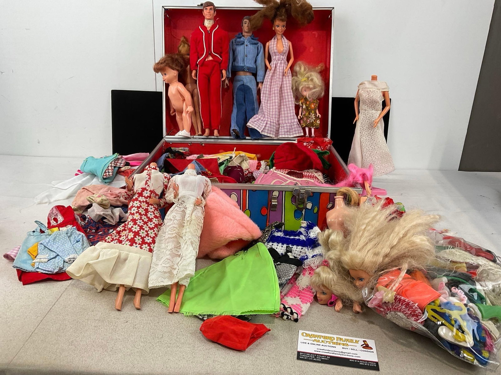 Vintage 1960s style Suitcase w/Dolls, Mattel Ken Doll, some Barbie Pieces, and lots of Clothes: Appears to be in good shape. The piece measures approx 13h x 17w x 7d inches. See pics. E-6300