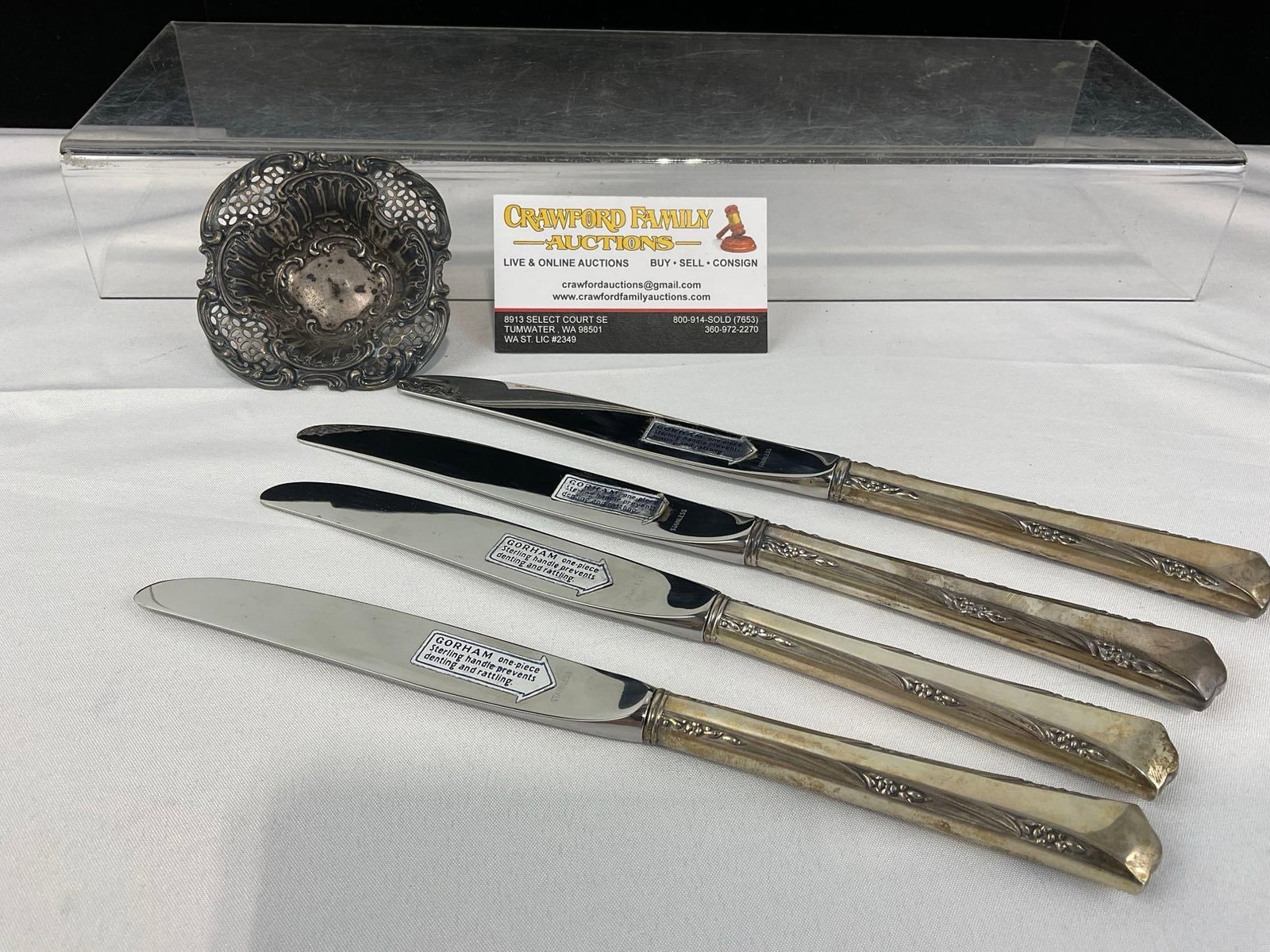 4 Gorham Knives w/Sterling Silver Handles, Stainless Blades, & Sterling Bowl, 298.4 grams in total: Appears to be in good shape. The piece measures approx 4h x 10w x 3d inches. The small bowl has a lion mark, denoting the sterling silver makeup of the piece. The pieces weigh a total of 298.4 grams,