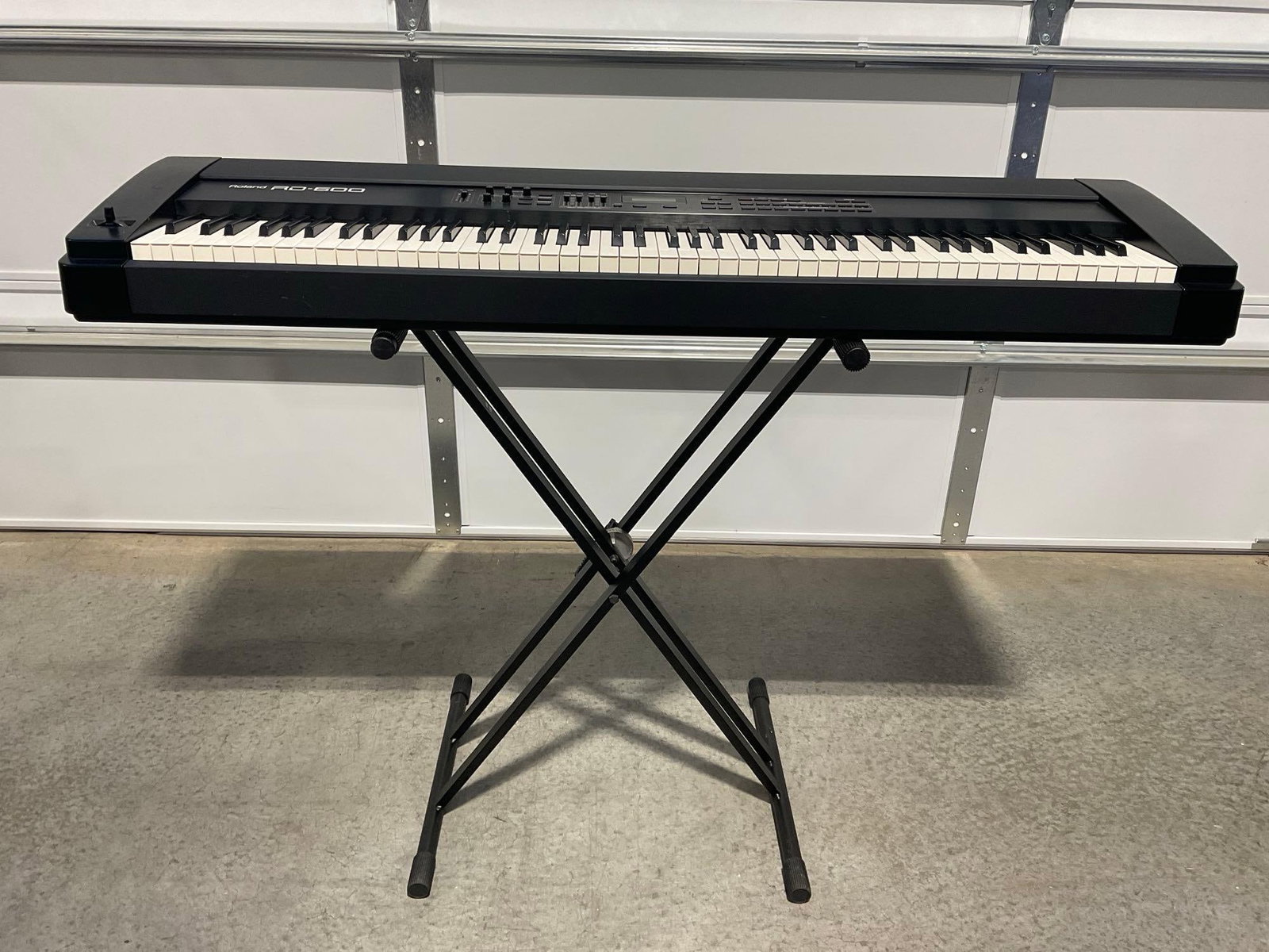 Roland RD-600 Digital Piano, 88 keys, no cables w/folding stand: No built in speakers, has midi and 1/4 inch inputs & outputs. Appears to be in good shape. Working and tested by consignor prior to drop-off. Just missing cables. The piece measures approx 10h x