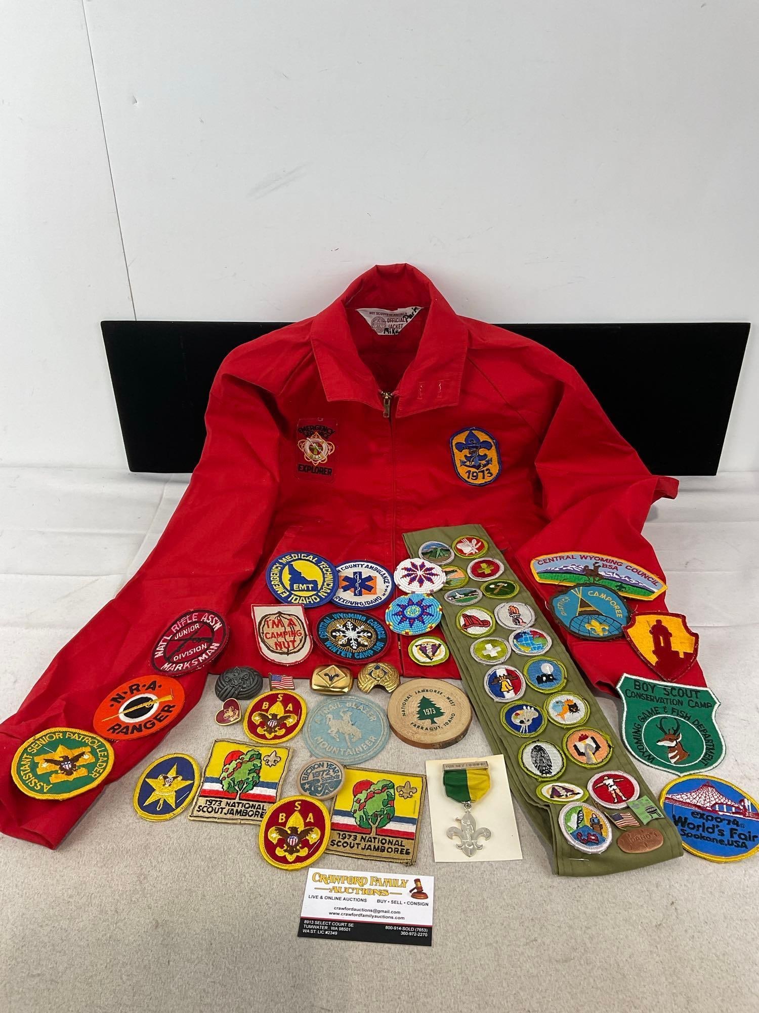 BSA Explorer Jacket, Merit Badge Sash, Variety of Patches, Kerchief Slides, Enamel Pins & more: Appears to be in good shape. The piece measures approx 12h x 8w x 5d inches. See pics. E-6600