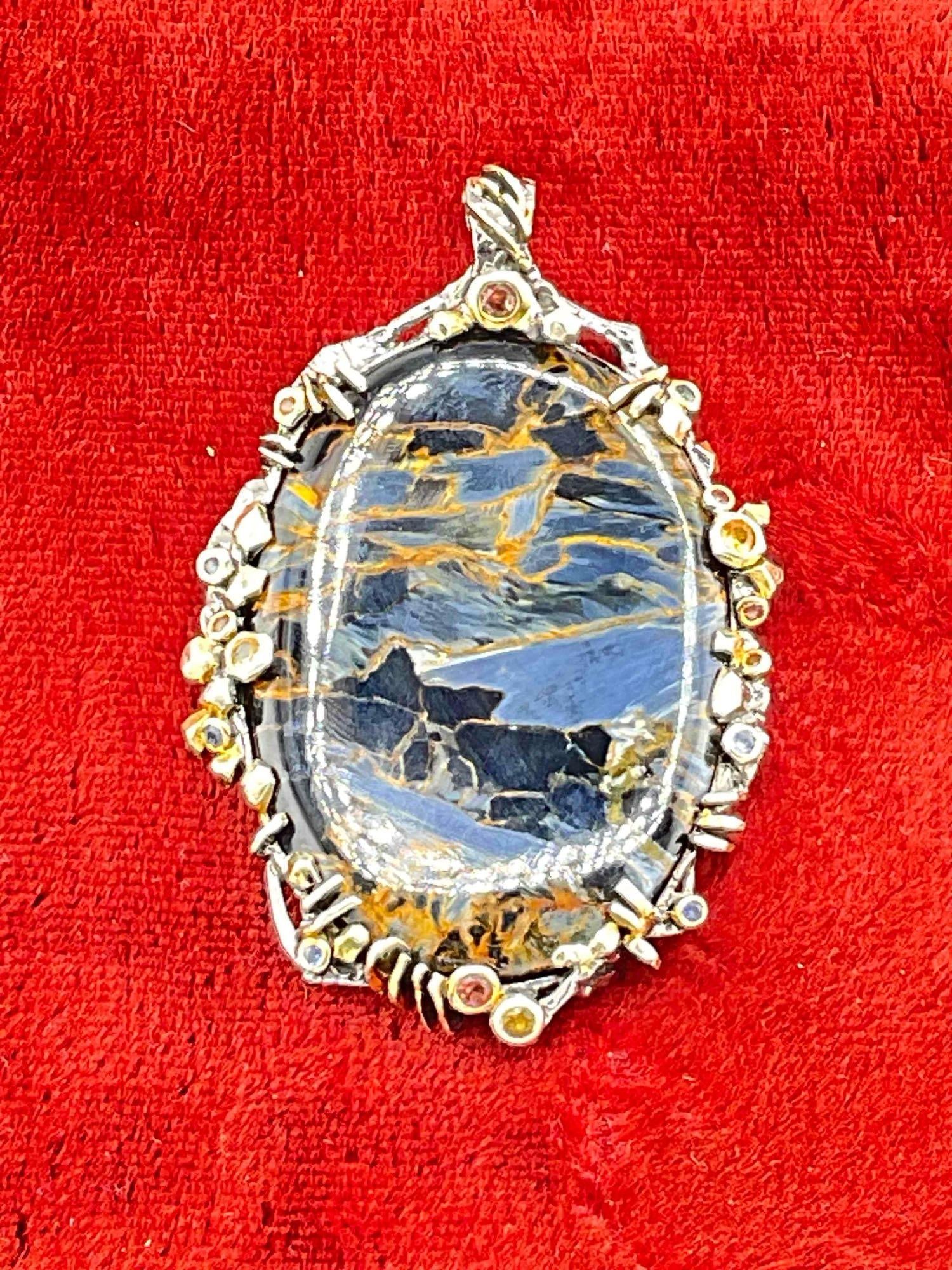 Pietersite Cabochon Set in Sterling Silver Bezel Pendant w/ Gold Accents & Multi Stone Settings.: Pietersite Cabochon Set in Sterling Silver Bezel Pendant w/ Gold Accents & Multi Stone Settings. Stunning stone with lovely accents of what looks to be gold plate and possibly sapphire toned