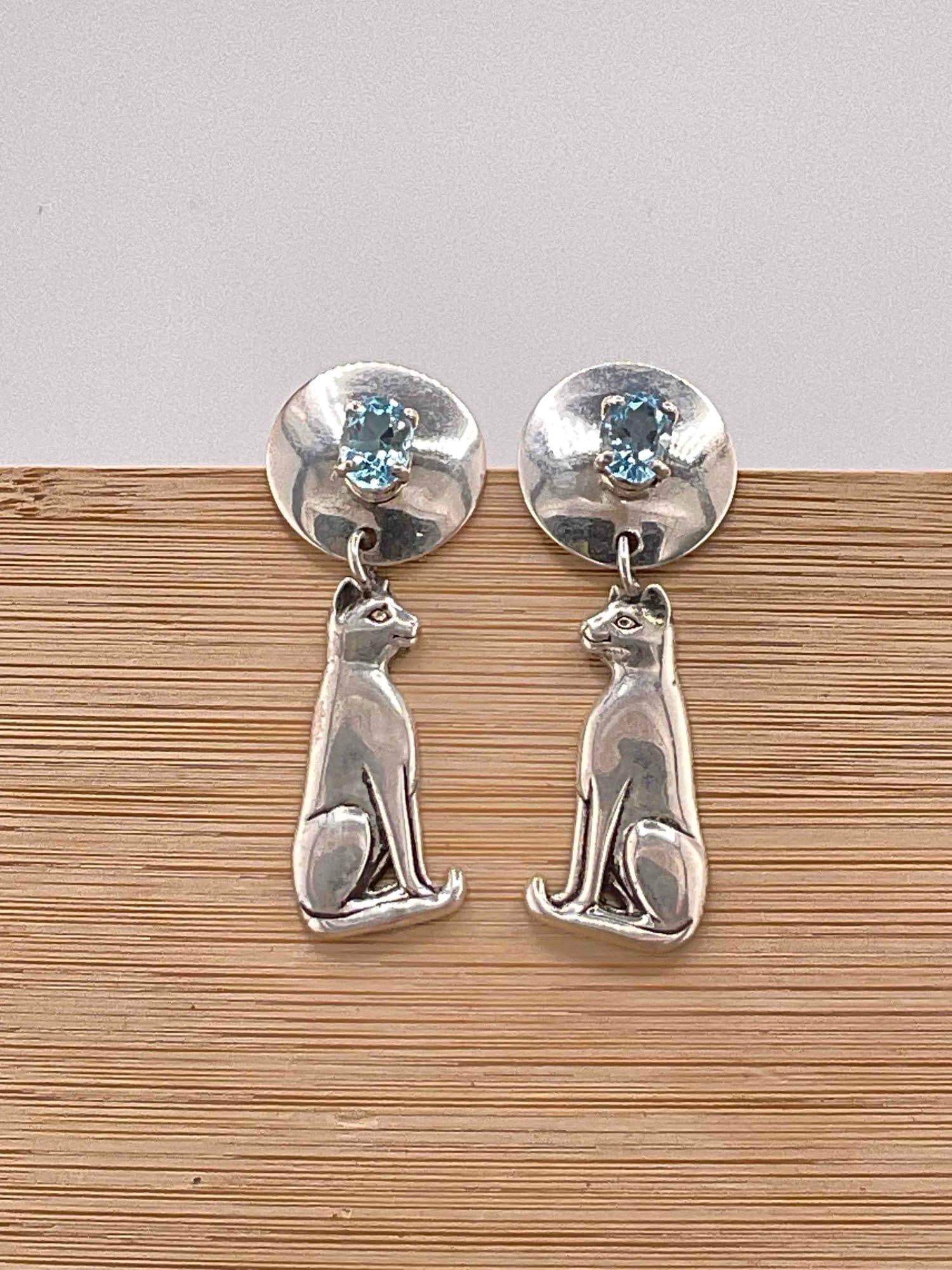 Vintage Carol Felley Sterling Silver Earrings w/ Cat Design & Blue Topaz Toned Settings. See pics.: Vintage Carol Felley Sterling Silver Earrings w/ Cat Design & Blue Topaz Toned Settings. Stamped 89 on reverse. Weighs 13 grams. Rubber earring backs are for photography purposes only, not include