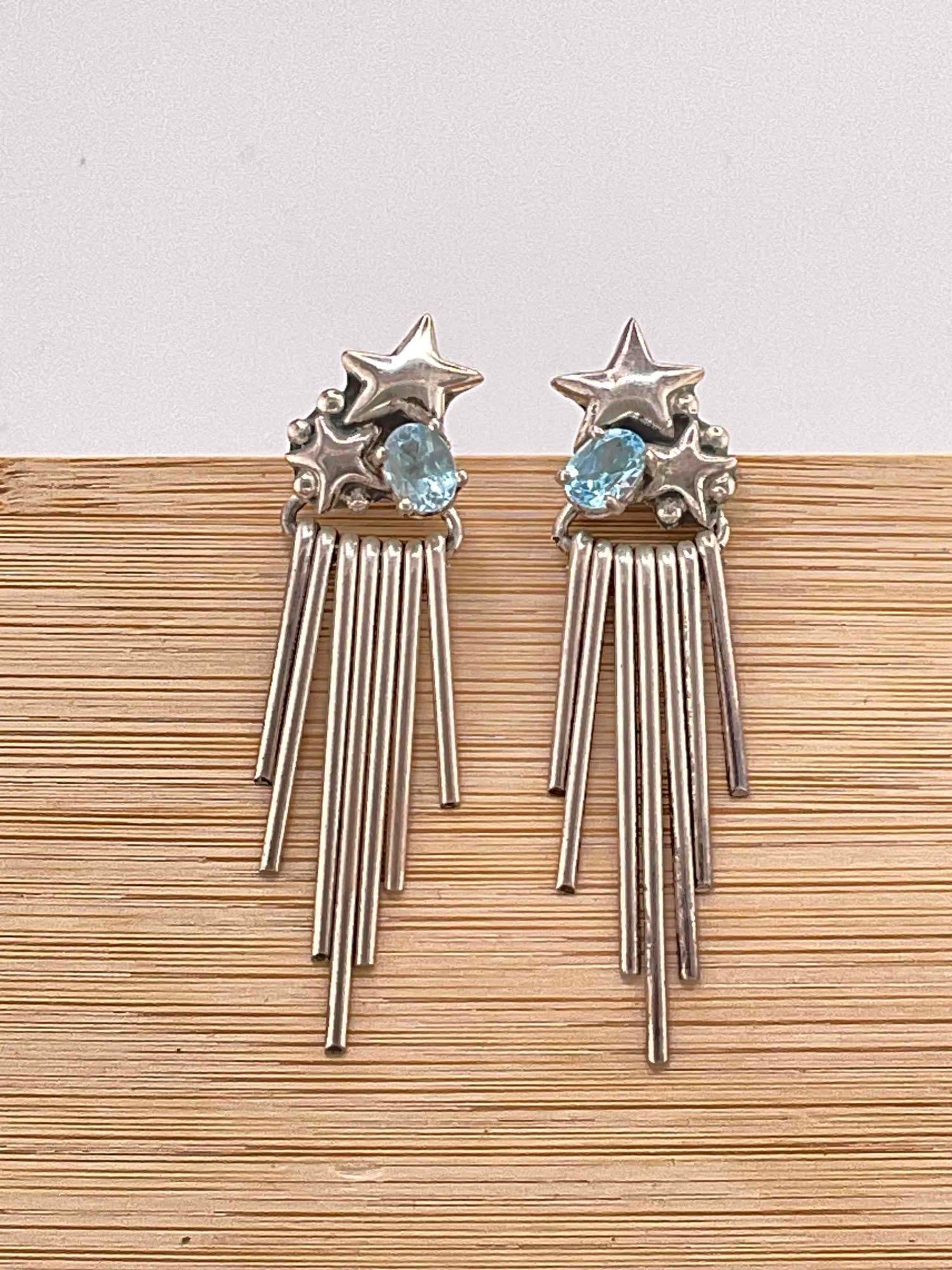 Vintage Carol Felley Sterling Silver Earrings w/ Star Design & Blue Topaz Toned Settings. See pics.: Vintage Carol Felley Sterling Silver Earrings w/ Star Design & Blue Topaz Toned Settings. Stamped 91 on reverse. Great movement. Weighs 12 grams. DM-414