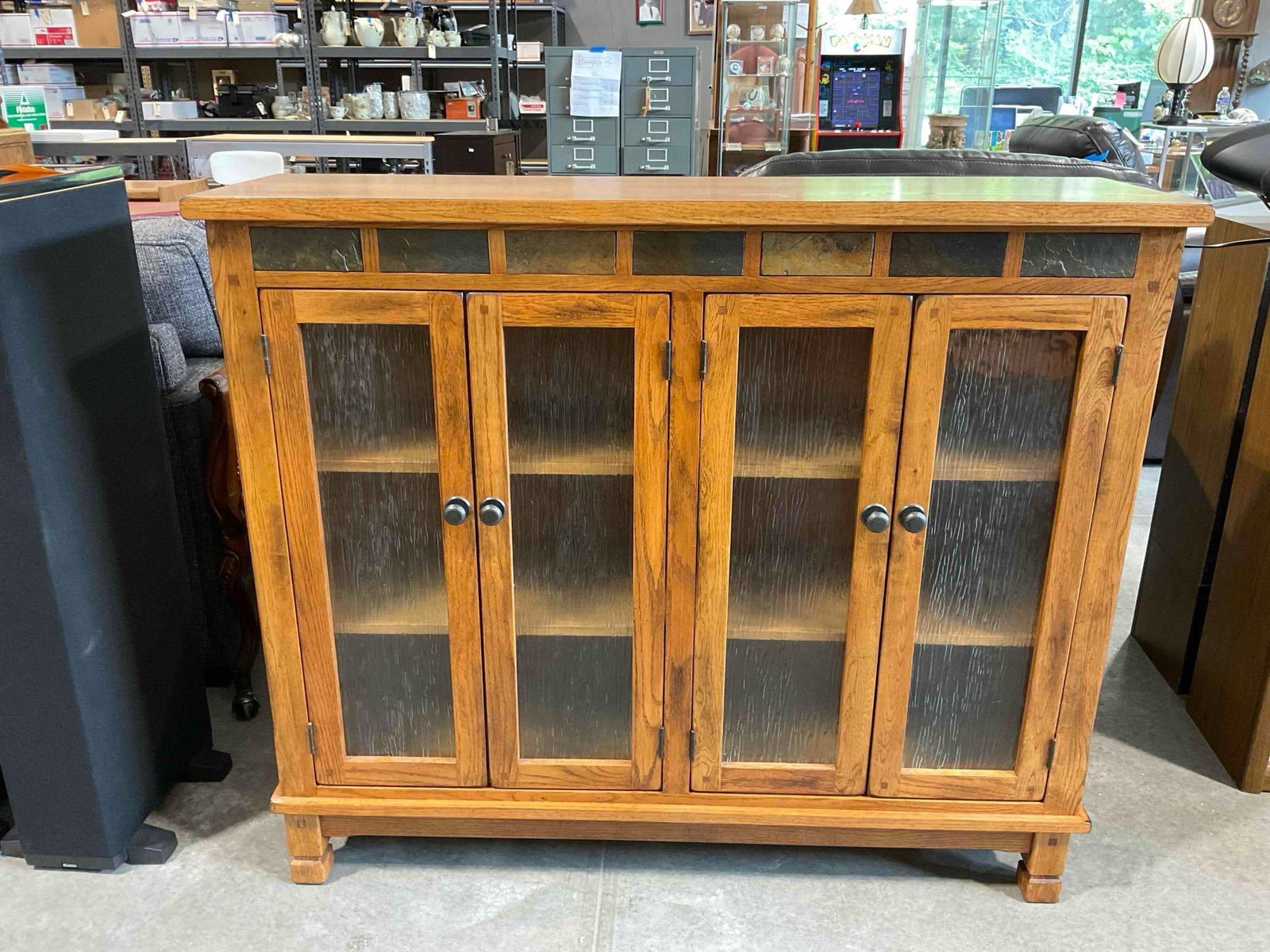 Sunny Designs Oak Finish Sedona Bookcase w/ Glass Fronted Cabinets & Stone Accent. See pics.: Sunny Designs Oak Finish Sedona Bookcase w/ Glass Fronted Cabinets & Stone Accent. Minor wear indicative of age and use, otherwise looks to be in good condition. Measures 50" x 14" x 42" DM-6580