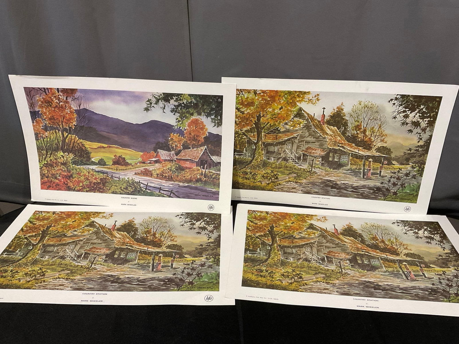 4 Mark Wheeler Prints, 3x Country Station & 1x Country Scene, 17x26 inches: Appears to be in good shape. The piece measures approx 17h x 26w x 3d inches. See pics. E-6610