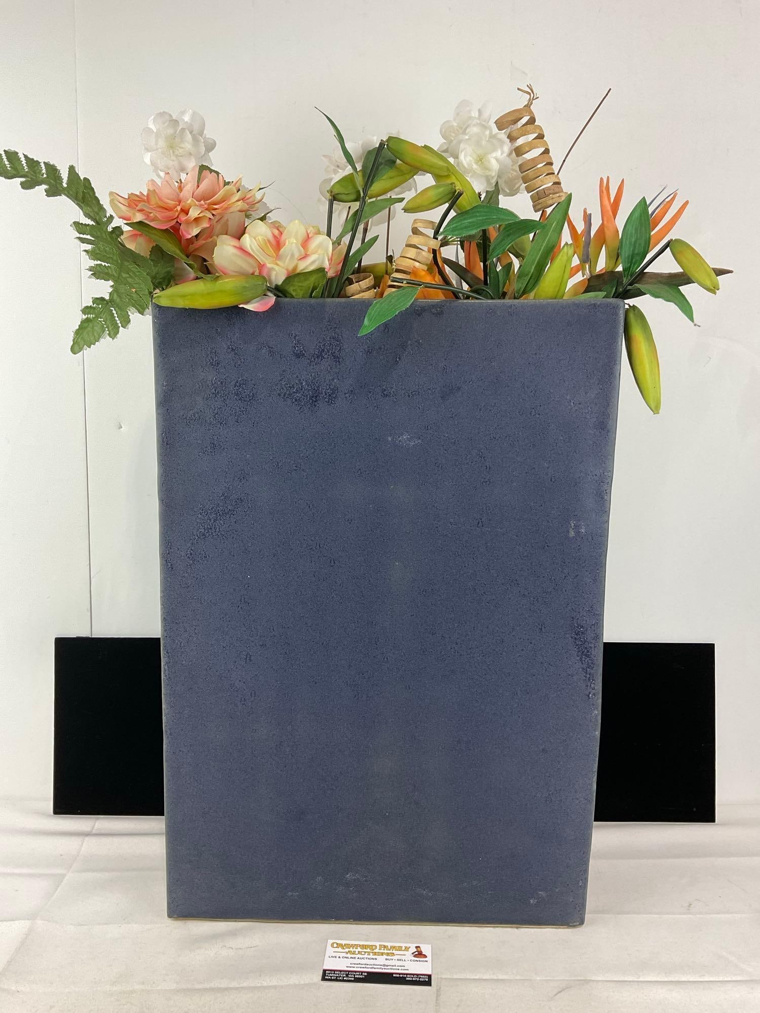 Tall Thin Purply Stoneware Planter, 29h x 16w x 5d inches w/faux floral arrangement: Appears to be in good shape. The piece measures approx 29h x 16w x 5d inches. See pics. E-414 *Oversized shipping may apply*