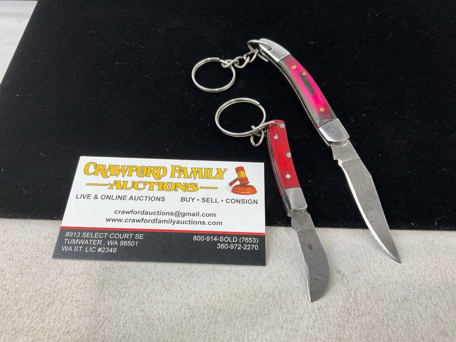 Pair of Small Folding Pocket Knives, Tinted Wood Handle Scales, Pink & Red, 1.5 inch blades: Appears to be in good shape. The blade measures approx 1.5 inches. In total the piece measures approx 5h x 2w x 2d inches. See pics. E-6500