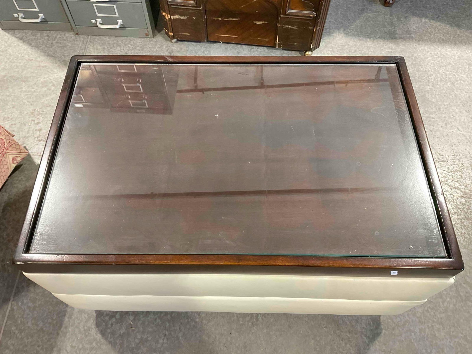 Modern Glass Topped Coffee Table w/ Wood & Cream Vinyl Base. Measures 35" x 23" x 17" See pics. (1 of 5)