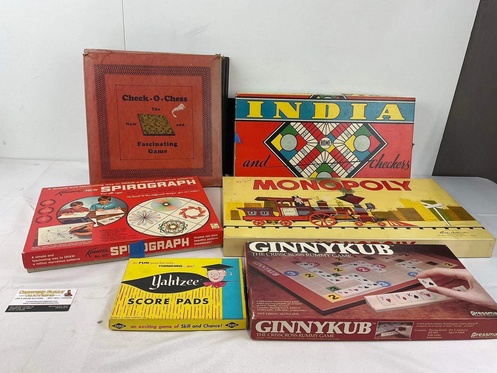 Vintage Boardgames, Kenners Spirograph, Check O Chess, India, Monopoly, Ginnykub, & Yahtzee Score...: Appears to be in fair shape, some wear or tape on a few of the boxes, unclear if there are missing pieces. A good selection of games. The piece measures approx 8h x 21w x 13d inches. See pics. E-6610