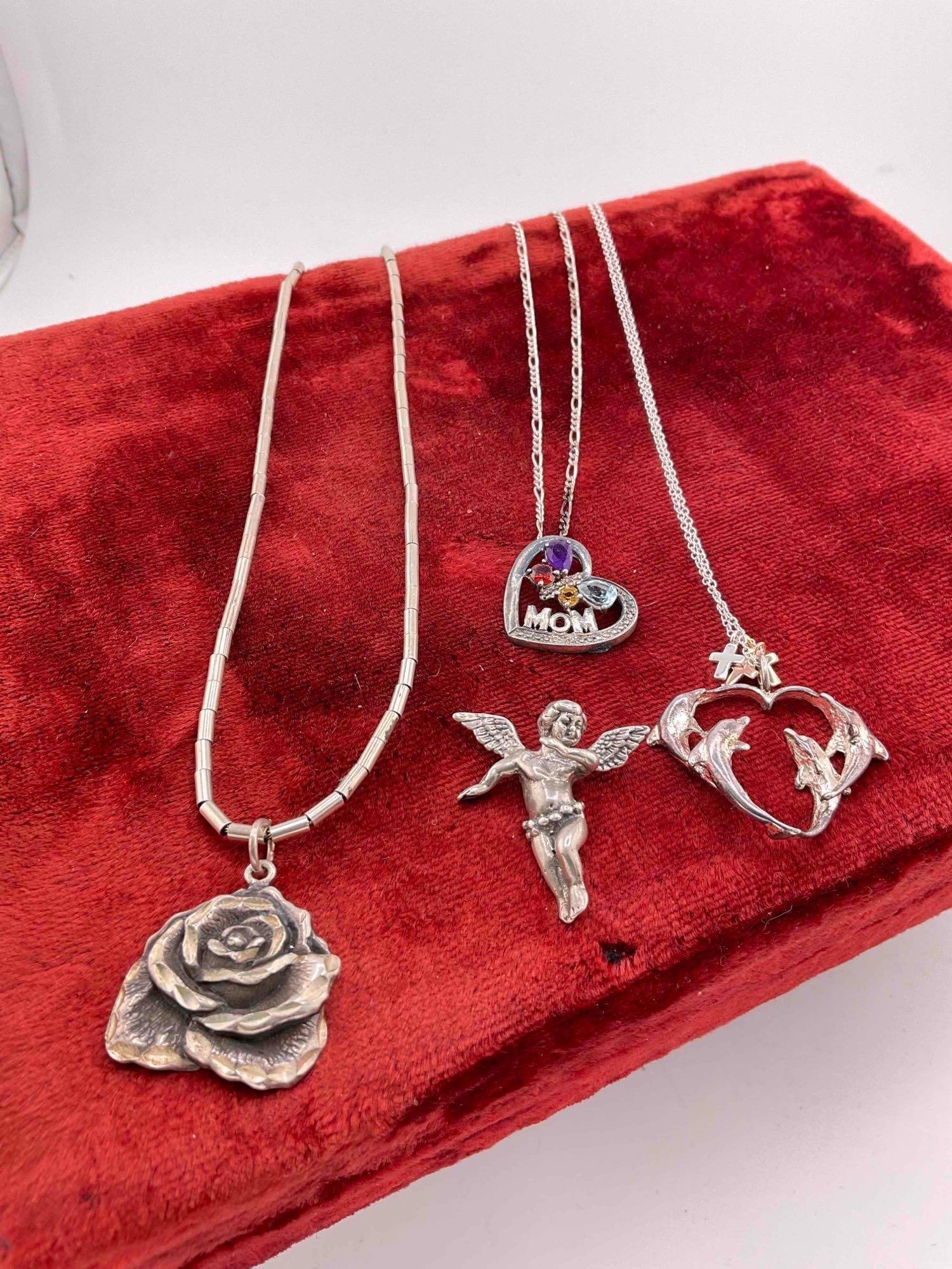 4 pcs Sterling Silver Pendants w/ 3 pcs Sterling Silver Chains.: 4 pcs Sterling Silver Pendants w/ 3 pcs Sterling Silver Chains. One pendant has multi-toned stone settings, looks to be birthstones. Necklaces measure 18" - 20". Weighs 34 grams.