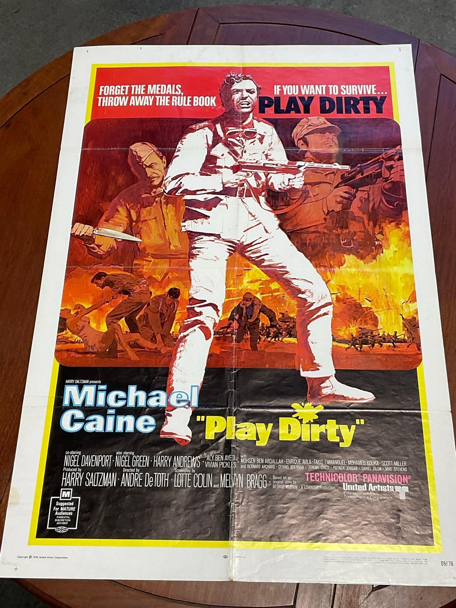 Vintage One Sheet Movie Poster 1969 Play Dirty Michael Caine w/Firey Scene in background: Marked 69/76. Vintage posters are in as is condition, consistent with age, see pics for condition. Quite a few pinholes, few interior tears as well. The poster measures approx 41h x 27w x 1d