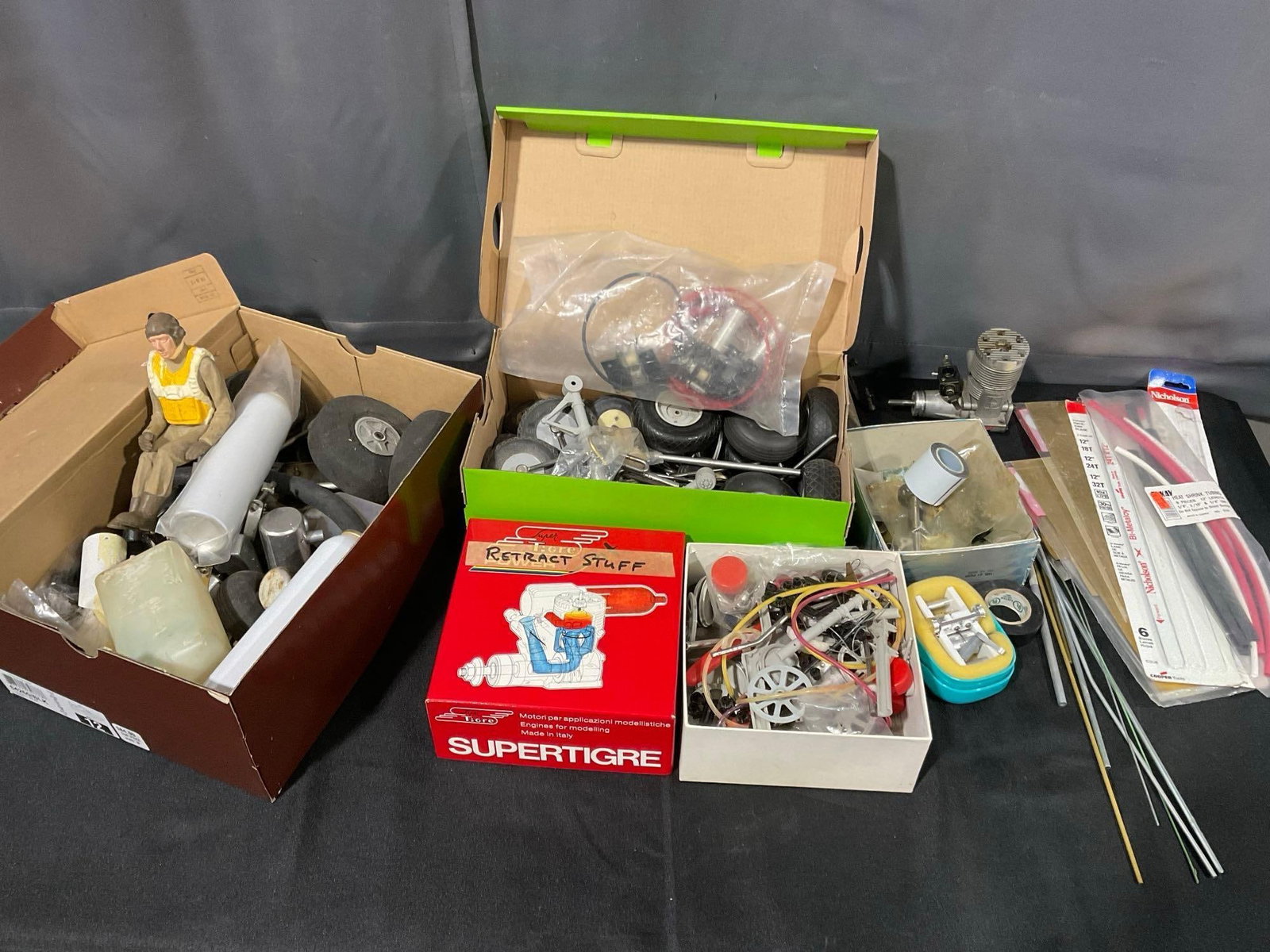 Collection of Model Airplane Parts, Wheels, Retractors, Couple Engines, & more: See pics for condition. Measures approx 10h x 20w x 20d inches. E-6260