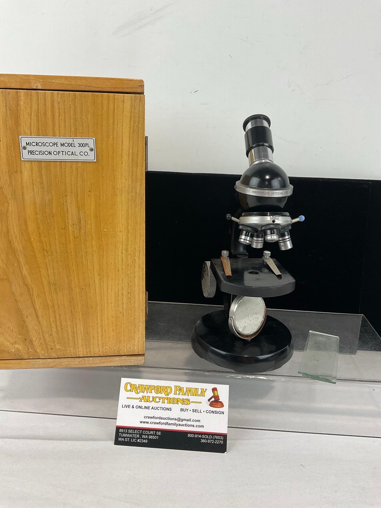 Precision Optical Microscope Model 300PL w/wooden case: See pics for condition. Shows some lost finish, and oxidation. The table adjustment seems to be disconnected from the dial. Measures approx 10h x 7w x 6d inches. E-6610