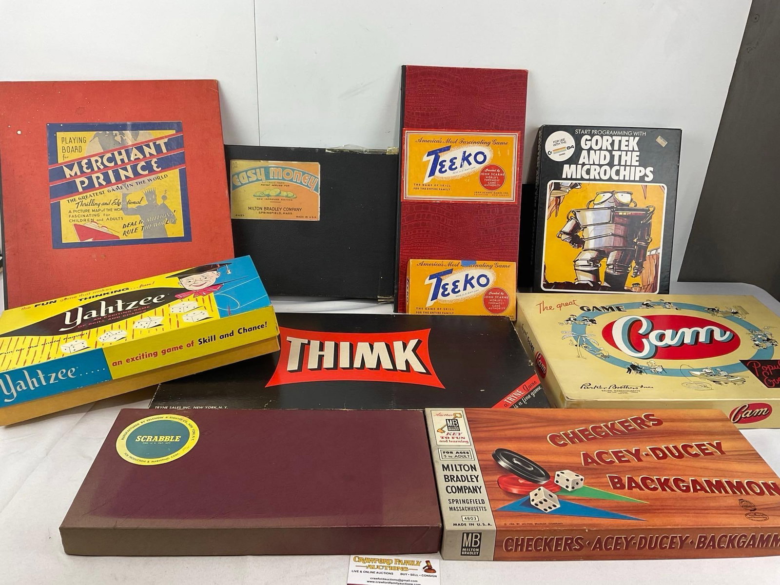 Variety of Vintage Boardgames, Scrabble, Thimk, Teeko w/board, Cam, Yahtzee, Merchant Prince Boar...: Easy Money board, Checkers, Acey-Ducey, Backgammon in one box. Some wear across the cardboard packaging, and some signs of age. See pics for condition. Measures approx 10h 24w x 17d inches. E-6610