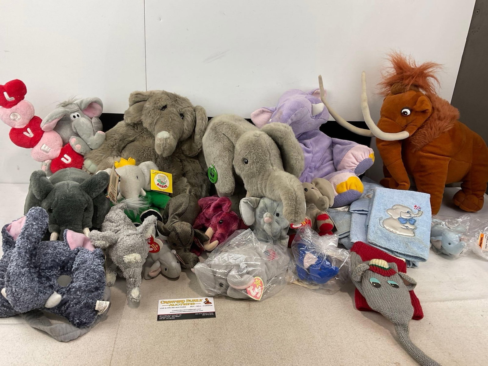 Several Elephant Plushes, Babar, Mammoth, Ty Beanie Babies, & more, approx 20 pieces: Appears to be in good shape. The piece measures approx 14h x 31w x 16d inches. See pics. E-6230