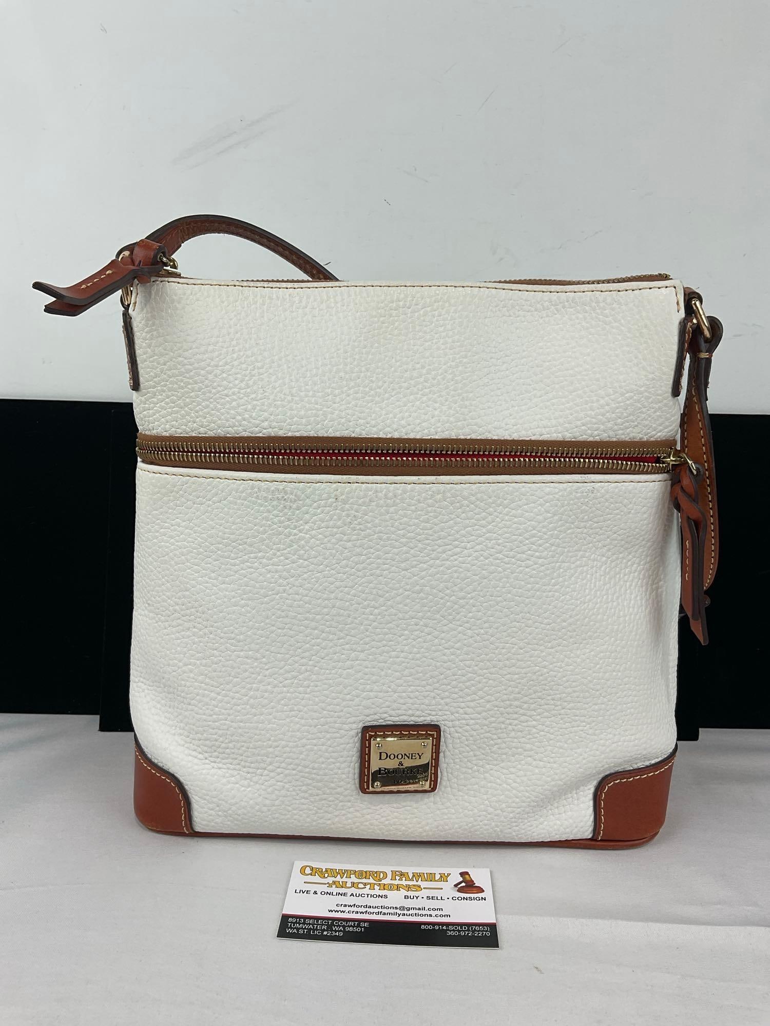 Dooney & Bourke White Pebbled Leather Crossbody Bag, w/Brown Trim, & Bright Red lining: See pics for condition. Measures approx 12h x 12w x 6d inches. E-6420