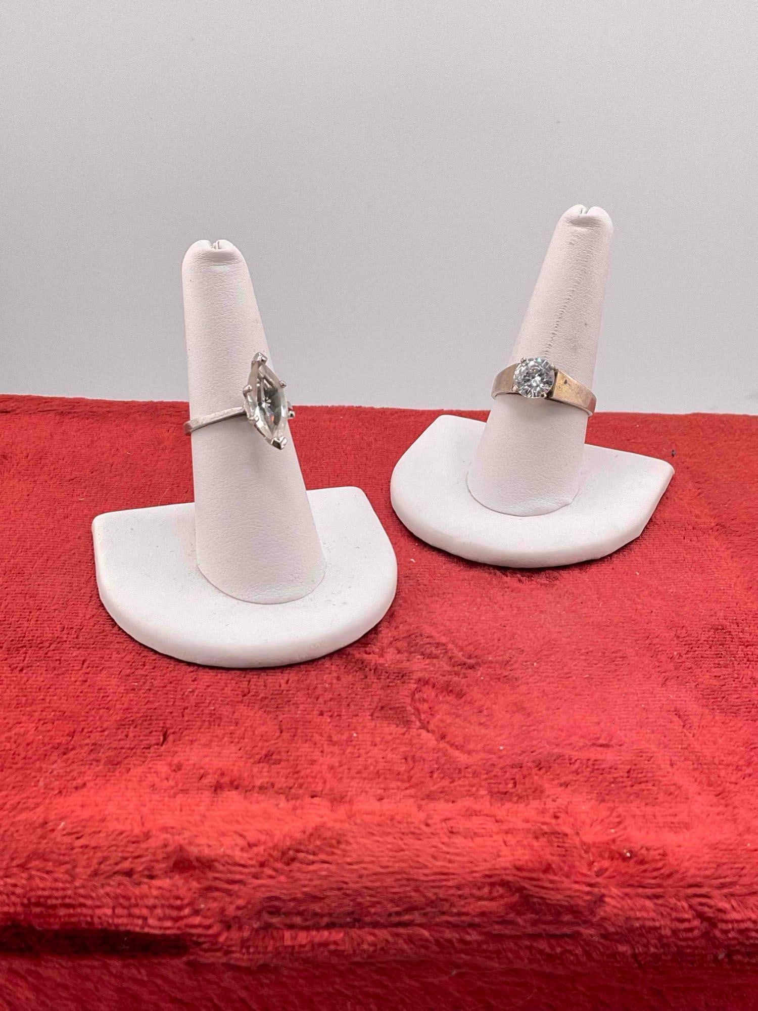 2 pcs Sterling Silver Rings w/ Cubic Zirconia Toned Settings. See pics.: 2 pcs Sterling Silver Rings w/ Cubic Zirconia Toned Settings. Assorted sizes. One is stamped KR. DM-414