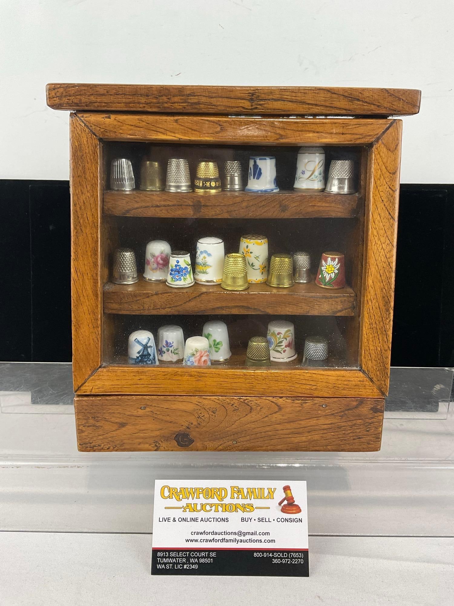 Small Thimble Display, Wooden Oak w/glass front, 9x9x4 in, Porcelain & Metal pieces, approx 24 pcs: See pics for condition. Measures approx 9h x 9w x 4d inches. E-6420
