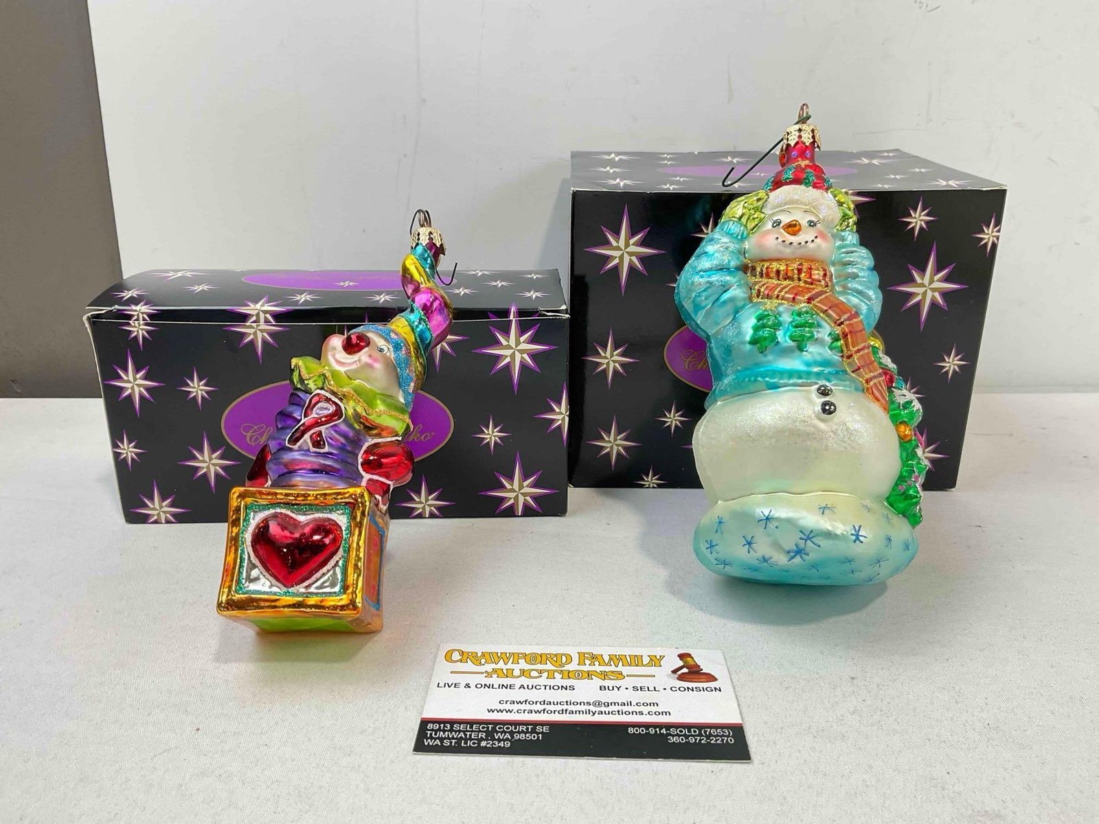 2 pcs Christopher RADKO Blown Glass Christmas Tree Ornaments w/ Boxes. See pics.: 2 pcs Christopher RADKO Blown Glass Christmas Tree Ornaments w/ Boxes. No chips or cracks, see photos for condition. Boxes may not be original to ornaments. Measures 8" x 6" x 9" DM-6670