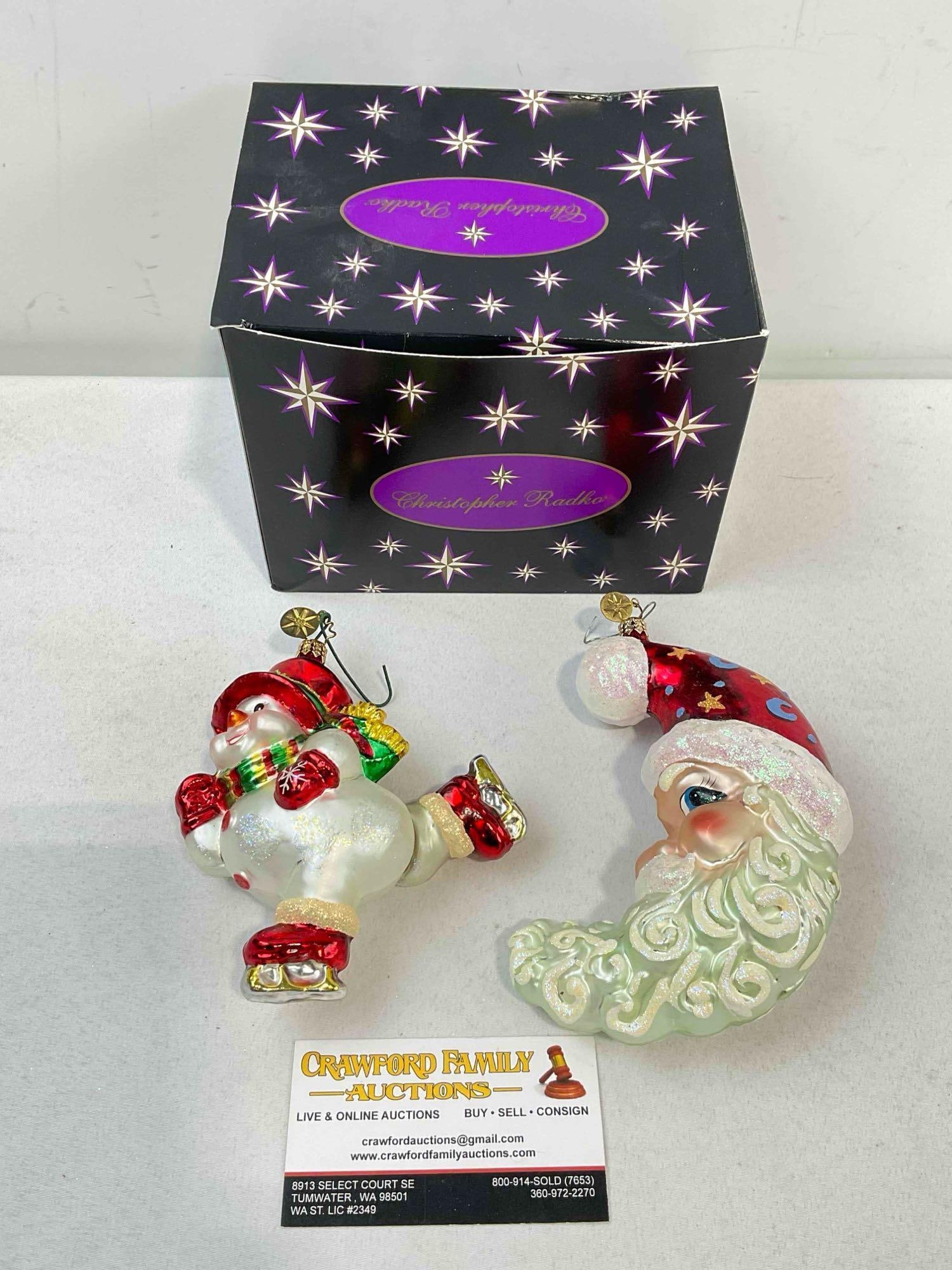2 pcs Christopher RADKO Blown Glass Christmas Tree Ornaments w/ Box. See pics.: 2 pcs Christopher RADKO Blown Glass Christmas Tree Ornaments w/ Box. No chips or cracks, see photos for condition. May not be the box original to the ornaments. Measures 7" x 5" x 6" DM-6670