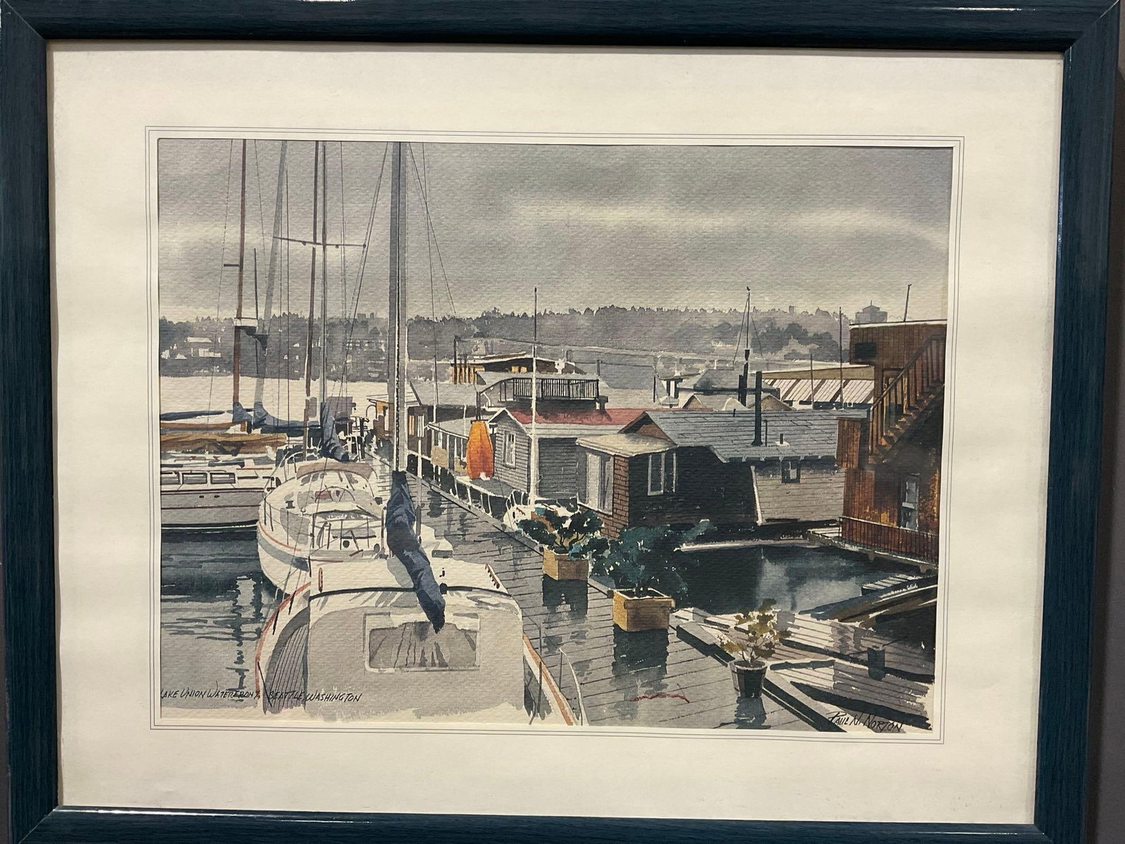 Framed Signed Watercolor Litho titled Lake Union Waterfront, Seattle Washington, by Paul N Norton: See pics for condition. Measures approx 16h x 20w x 3d inches. E-6420