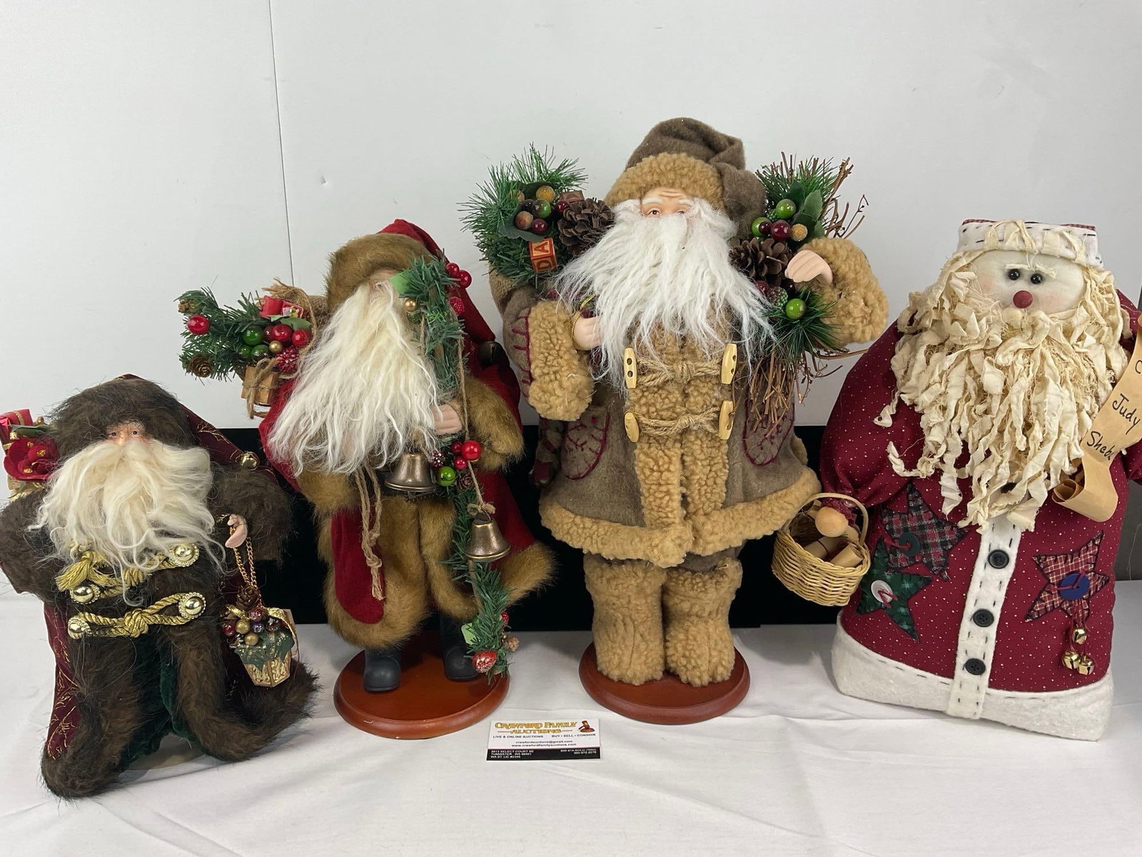 4 Santa Figures, 1 Tree topper, 1 Cloth w/sand in bottom & 2x Holiday Home: See pics for condition. Measures approx 25h x 17w x 12d inches. E-6420