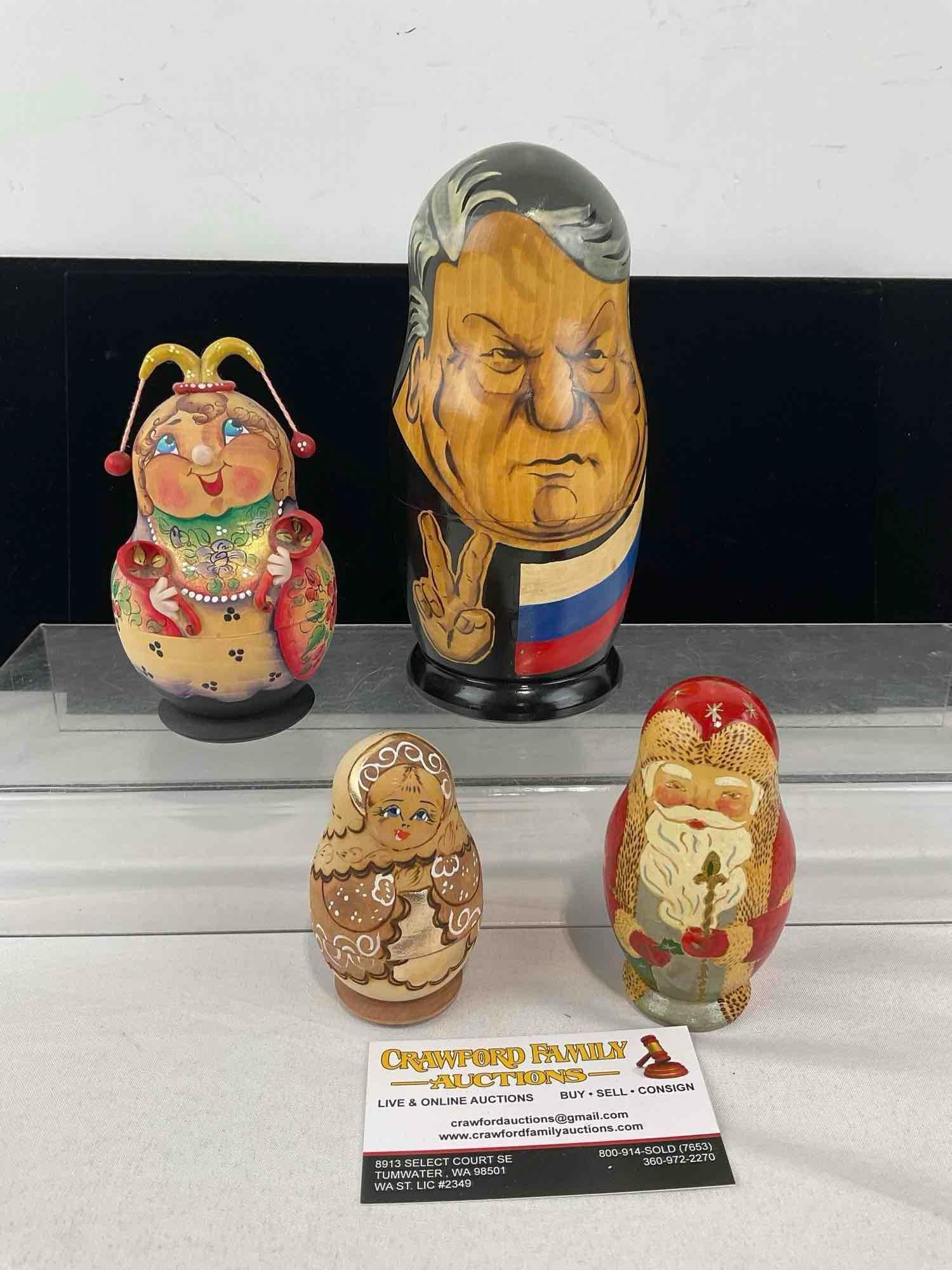 Set of 4 Nesting Dolls, Matryoshka, Santa, 2x Woman, & Soviet Leader Sets, handpainted pieces: See pics for condition. Measures approx 10h x 6w x 6d inches. E-6620