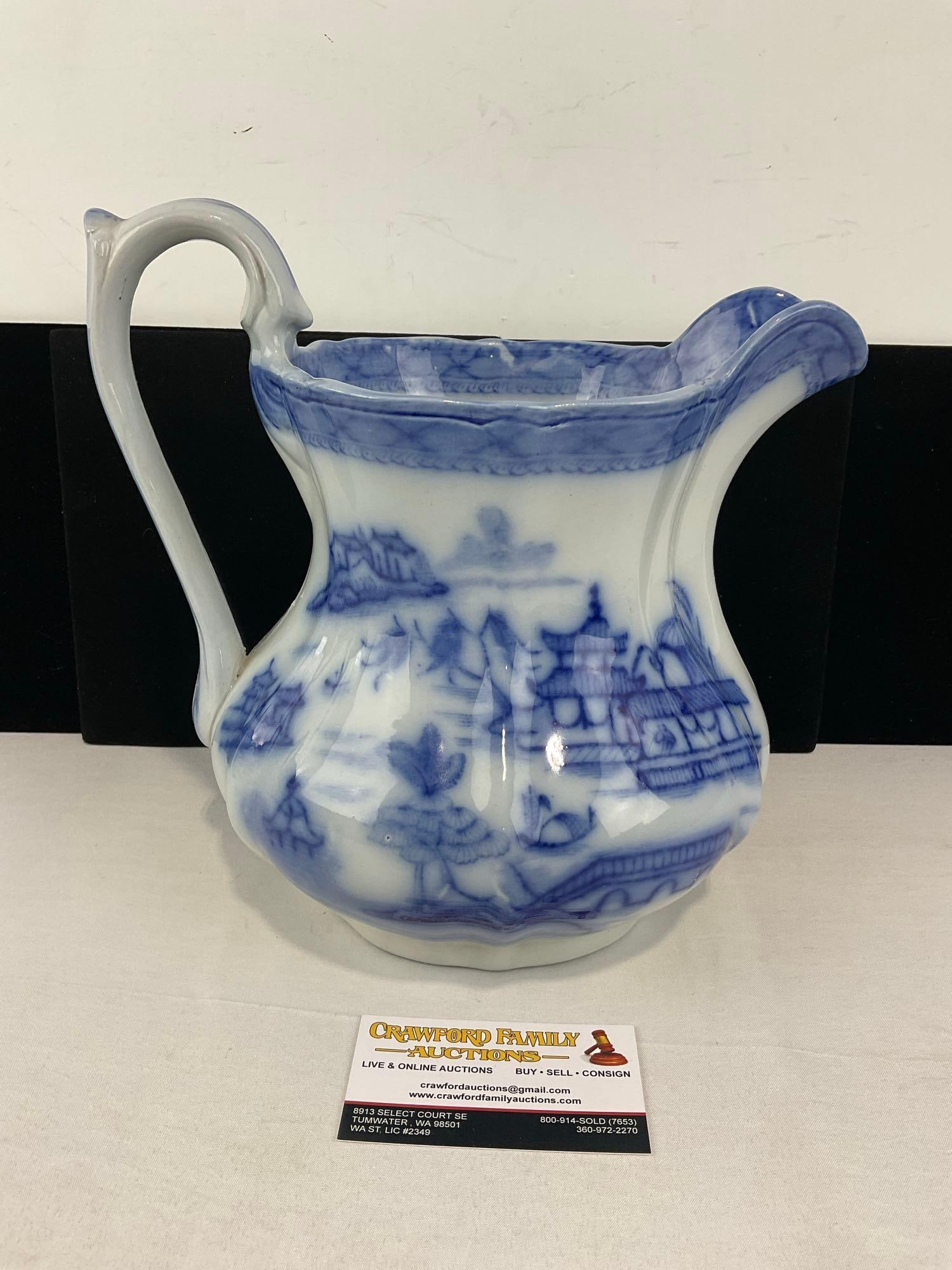 Antique Flow Blue Ironstone Ashworth Bros Hanley England Pitcher, 11h x 12w x 10d inches: The handle shows signs of separating, a crack down the edge. See pics for condition. Measures approx 11h x 12w x 10d inches. E-6620
