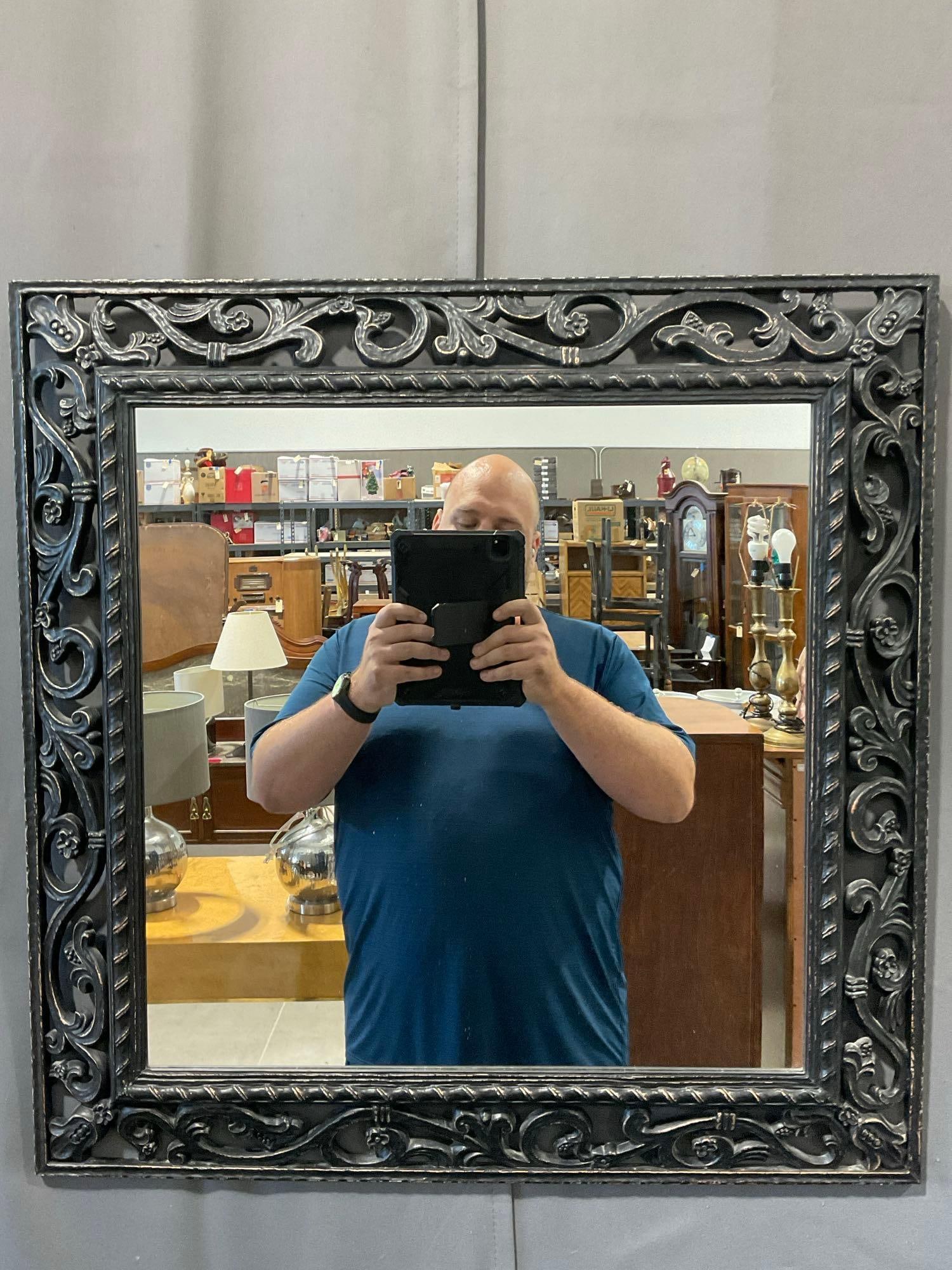 Decor Mirror, Black Plastic Scrollwork style Frame 27x27 inches: *No in-house shipping, fragile and/or oversized* See pics for condition. Measures approx 27h x 27w x 3d inches. E-6290 *Freight Required if shipped, Buyer Arranged/Responsibility*
