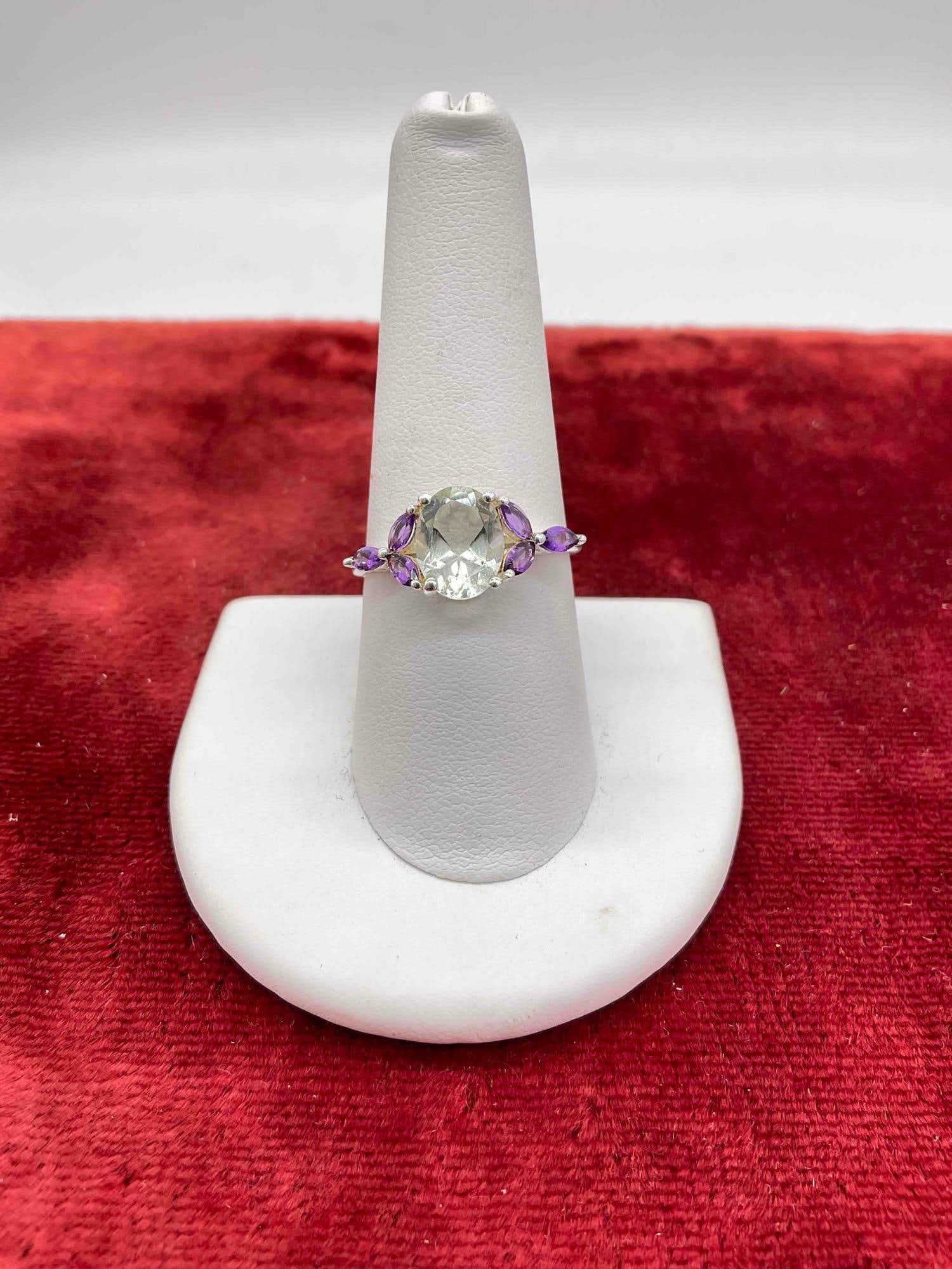 Elegant Sterling silver women's ring w/approx 1 + ct Aquamarine center stone, flanked with amethyst: c-6630 Sz 9 Stunning ring Stone is most likely oval cut Aquamarine or green amethyst. stones have been tested.