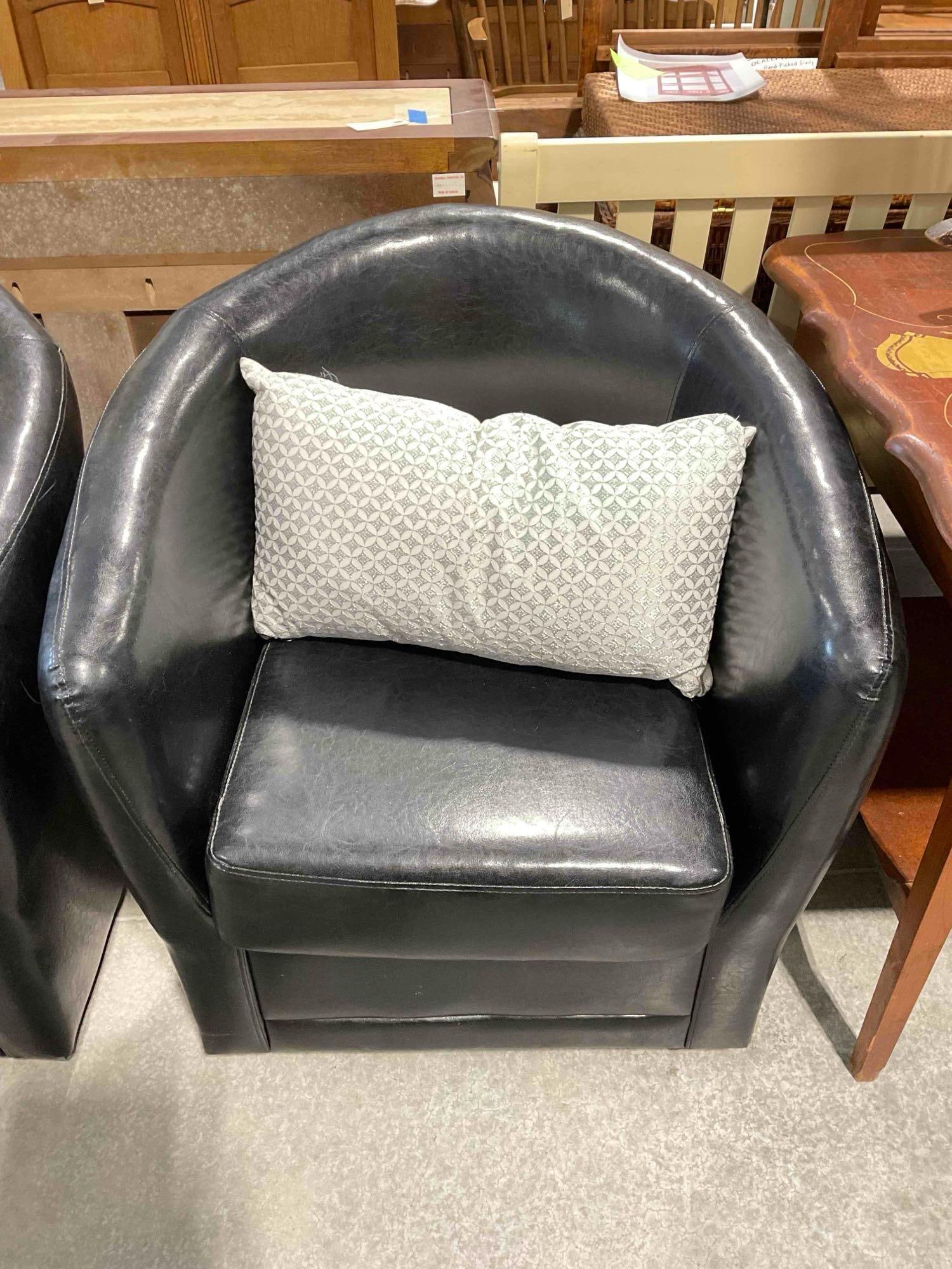 Targeted Marketing Black Faux Leather Barrel Swivel Chair w/ Silver Accent Pillow. See pics.: Targeted Marketing Black Faux Leather Barrel Swivel Chair w/ Silver Accent Pillow. Twin to lot 228. Minor wear indicative of age and use, see photos for condition. Measures 30" x 30" x 32" DM-6290