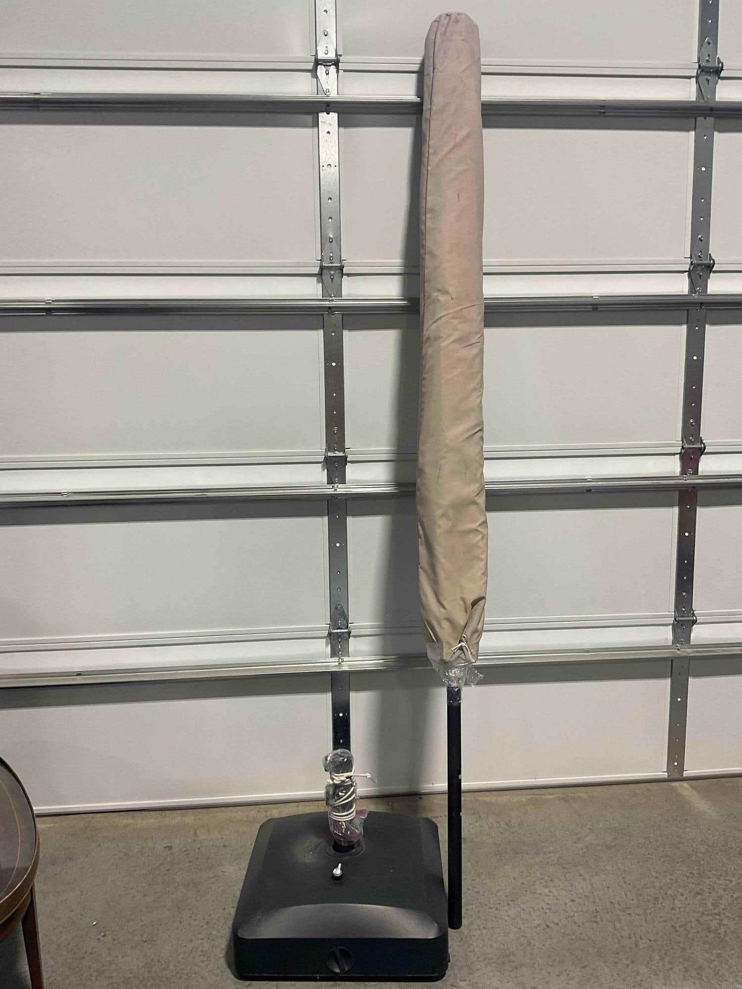 Tan Colored Canvas Patio Umbrella w/ Base. Stands 100" Tall! See pics.: Tan Colored Canvas Patio Umbrella w/ Base. Stands 100" Tall! Cannot be installed as base cannot support weight as is. Base measures 22" x 22" x 10", umbrella in case measures 8" x 8" x 100" Has been s