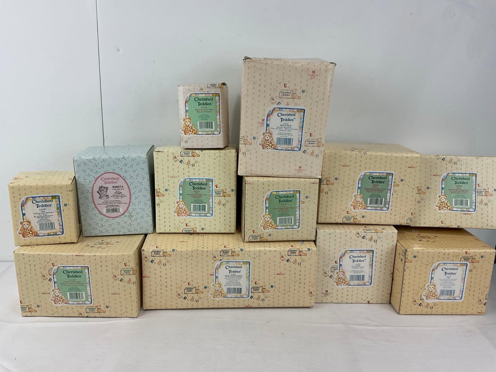12 Enesco Cherished Teddies Figurines in box: Unchecked for wear. See pics for condition. Measures approx 19h x 24w x 14d inches. E-6670
