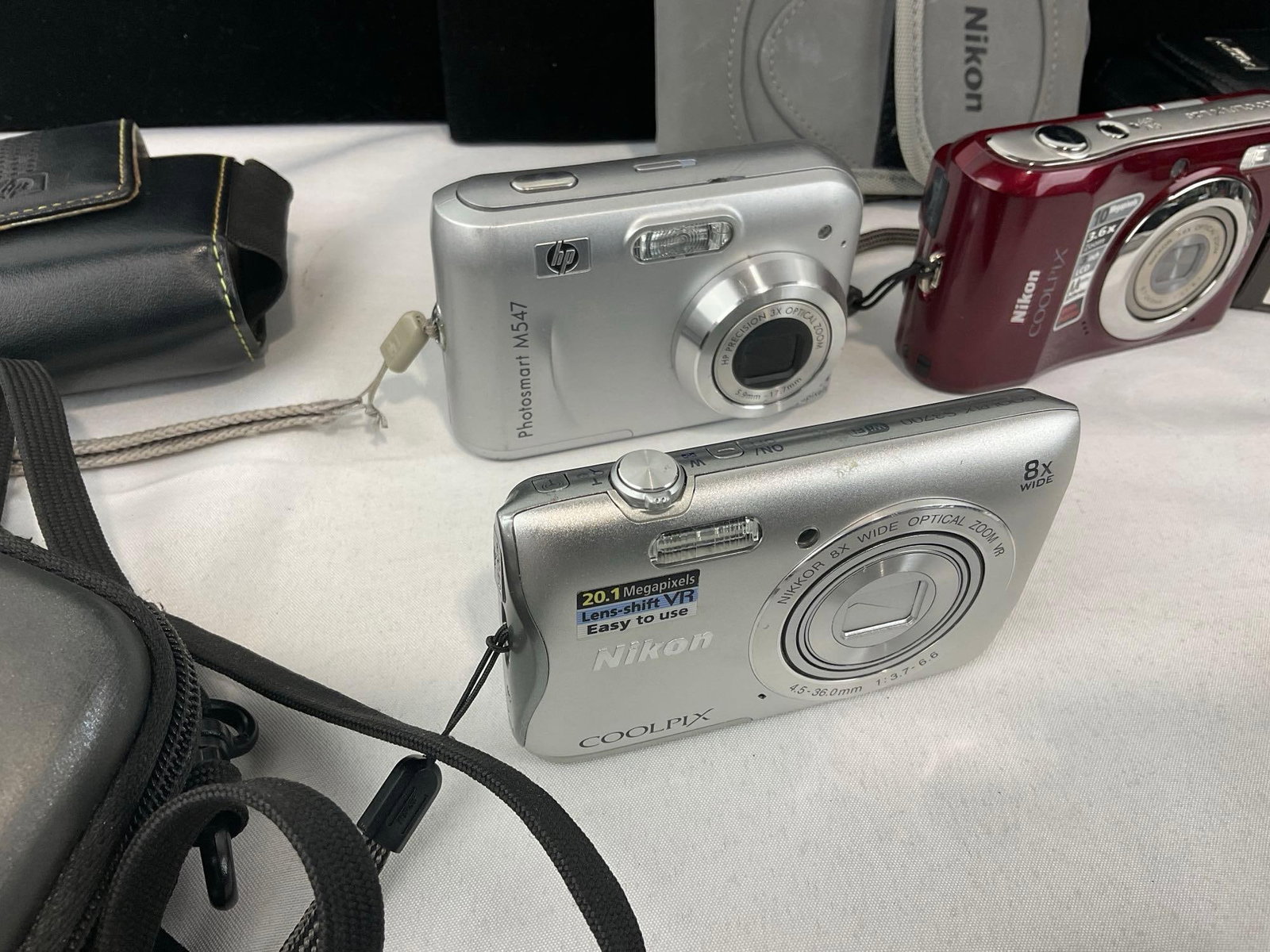 Variety of Digital Cameras, several Nikon Coolpix, Samsung L77, Canon PowerShot SD750 & SD1000 - 2