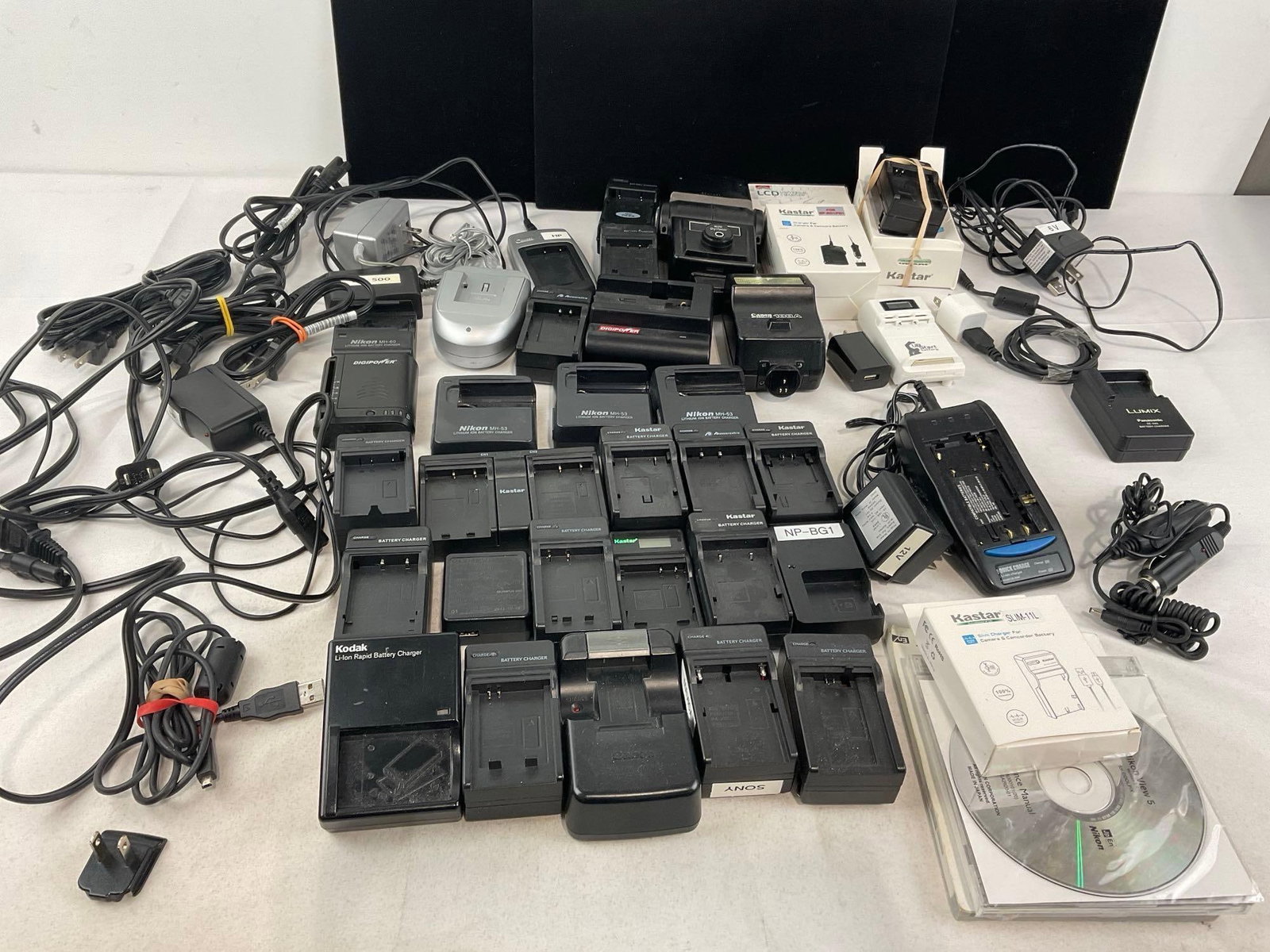 Large Selection of Battery Chargers, for Cameras, Camcorders & more, Kodak, Nikon, Canon & more: See pics for condition. Measures approx 12h x 15w x 10d inches. E-4320