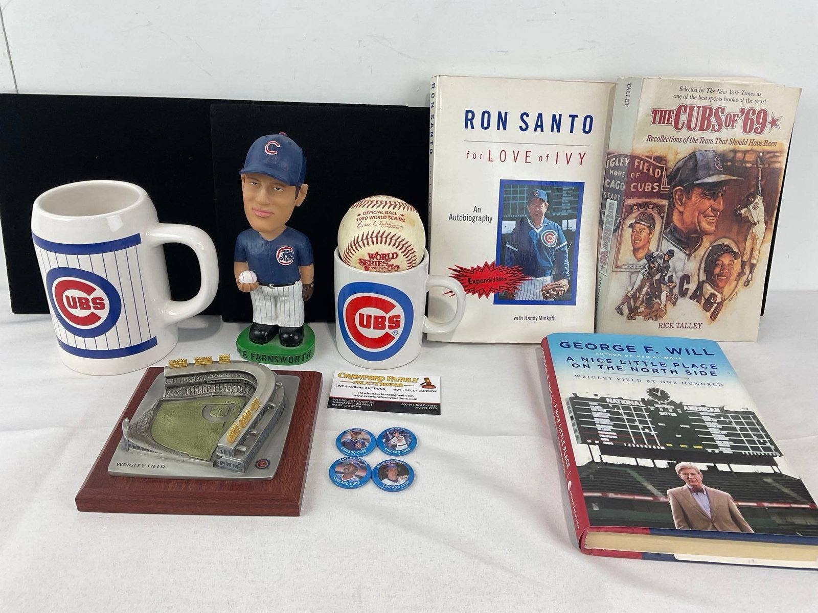 Signed Ron Santo Book, 2 Cubs Mugs, Kyle Farnsworth Bobblehead, 1980 World Series Ball, Wrigley ....: Wrigley Field Pewter Figure, & 2 Books, The Cubs of 69 & A Nice Little Place on the North Side. These sports lots are from a single consignor sports collection, including memorabilia hand