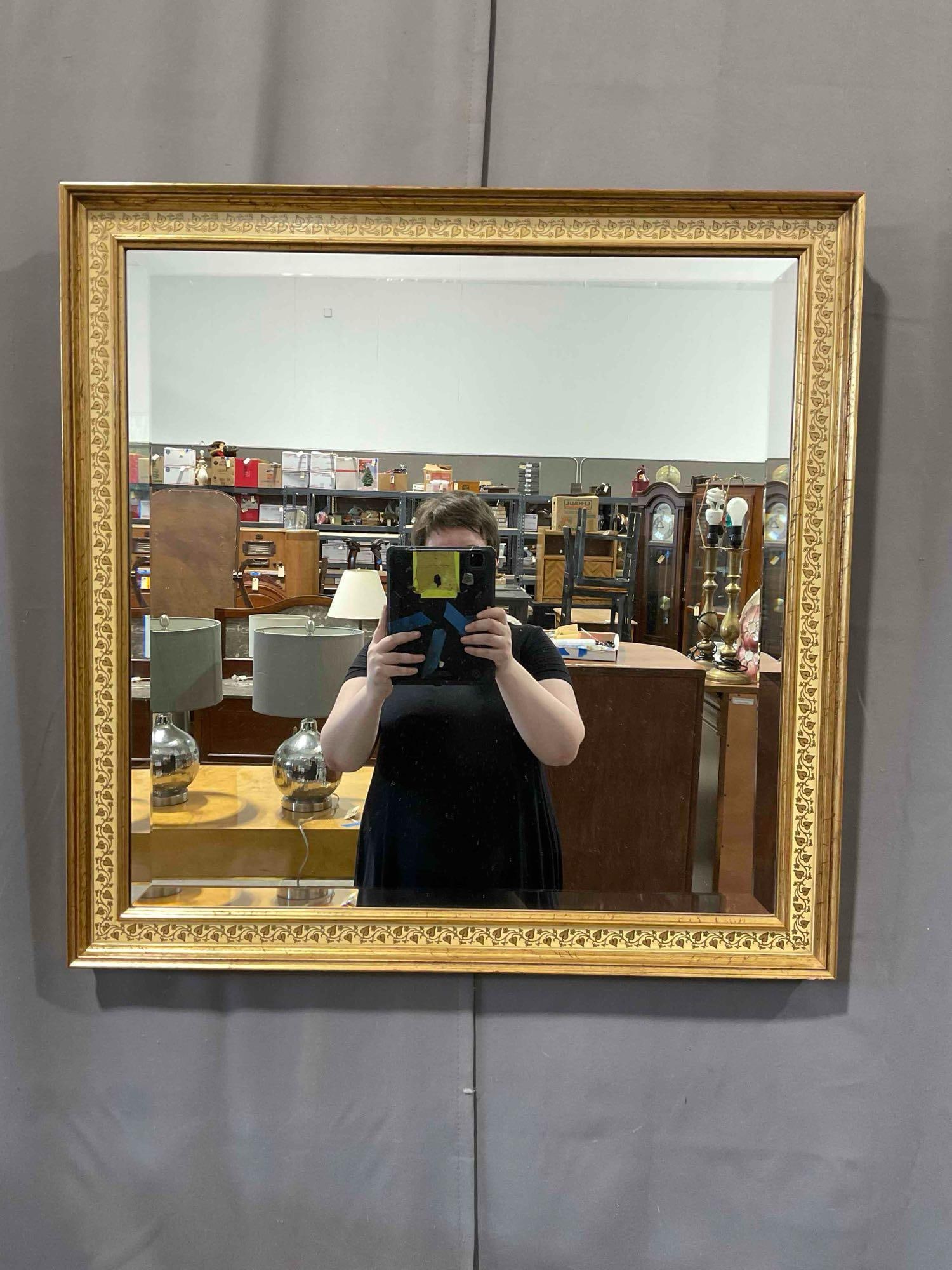 Modern Bevelled Wall Mirror in Gilt Wood Frame w/ Vine & Leaf Pattern. Measures 28" x 28" x 3": Modern Bevelled Wall Mirror in Gilt Wood Frame w/ Vine & Leaf Pattern. 28" x 28" x 3". Small chip on front, paint job is imperfect, has some tears on reverse, see photos for condition. Pair with
