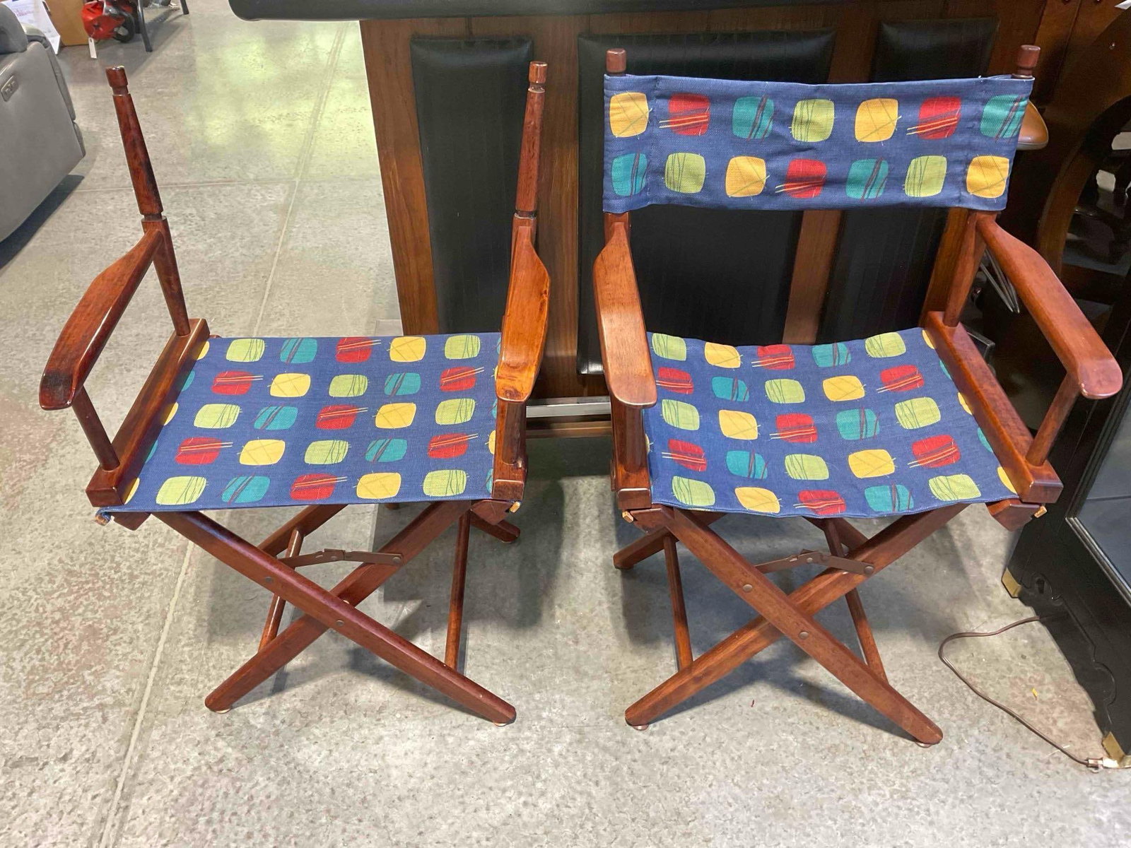 Pair of Folding Wood Director Chairs w/ Colorful Fabric Seats. See pics.: Pair of Folding Wood Director Chairs w/ Colorful Fabric Seats. One is missing chair back, see photos for condition. Measures 23" x 16" x 36" DM-6750