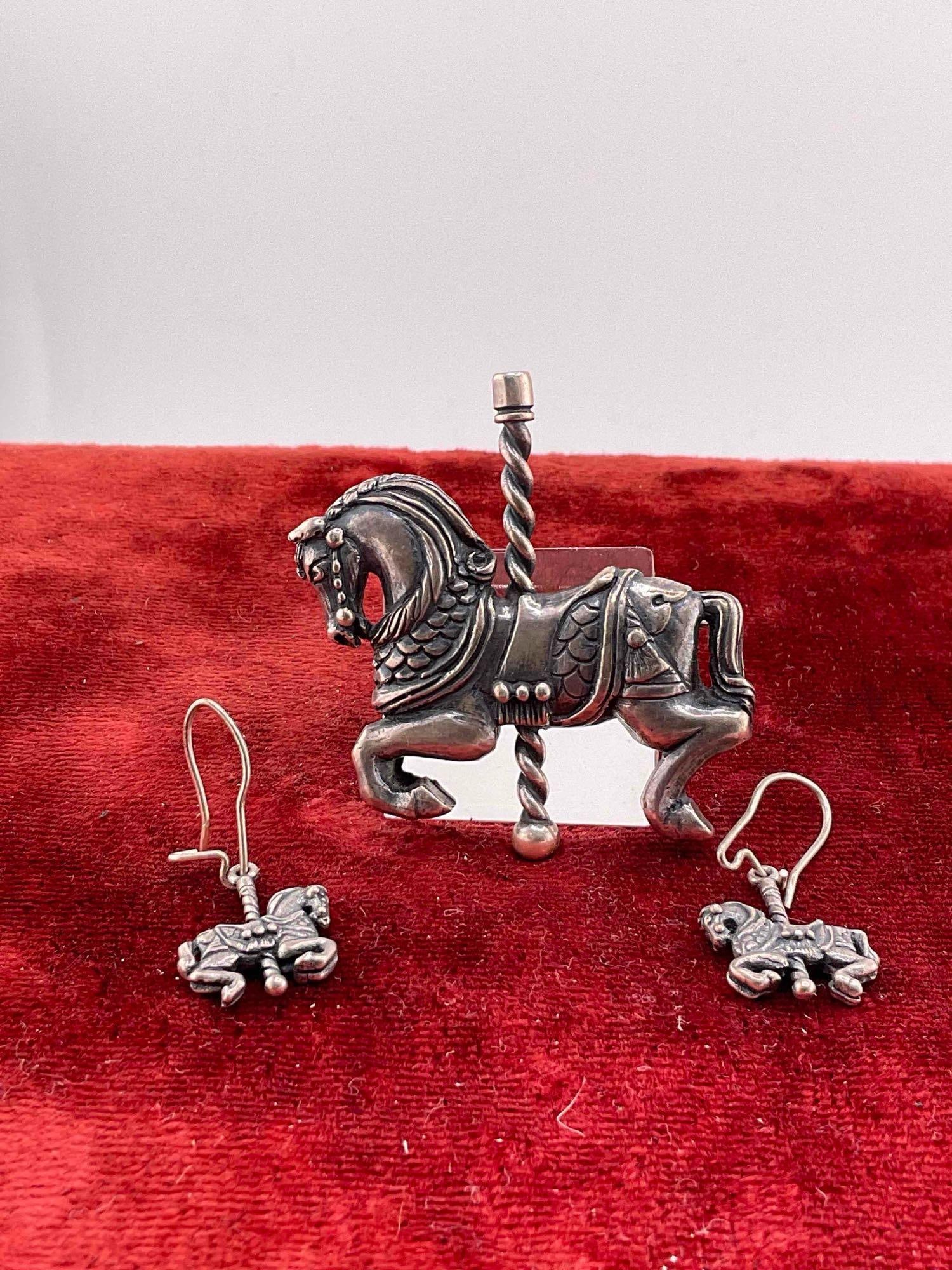 Extremely Rare Mid century James Avery Sterling Silver Carousel Horse Brooch W/ matching earrings: C-6620 Pieces are retired & marked Valued 300-500 pendant is 2"x 2" / 22.73 Grams The JA hallmark paired with a candelabra (a small stamped candlestick/candelabra pictorial logo) is the