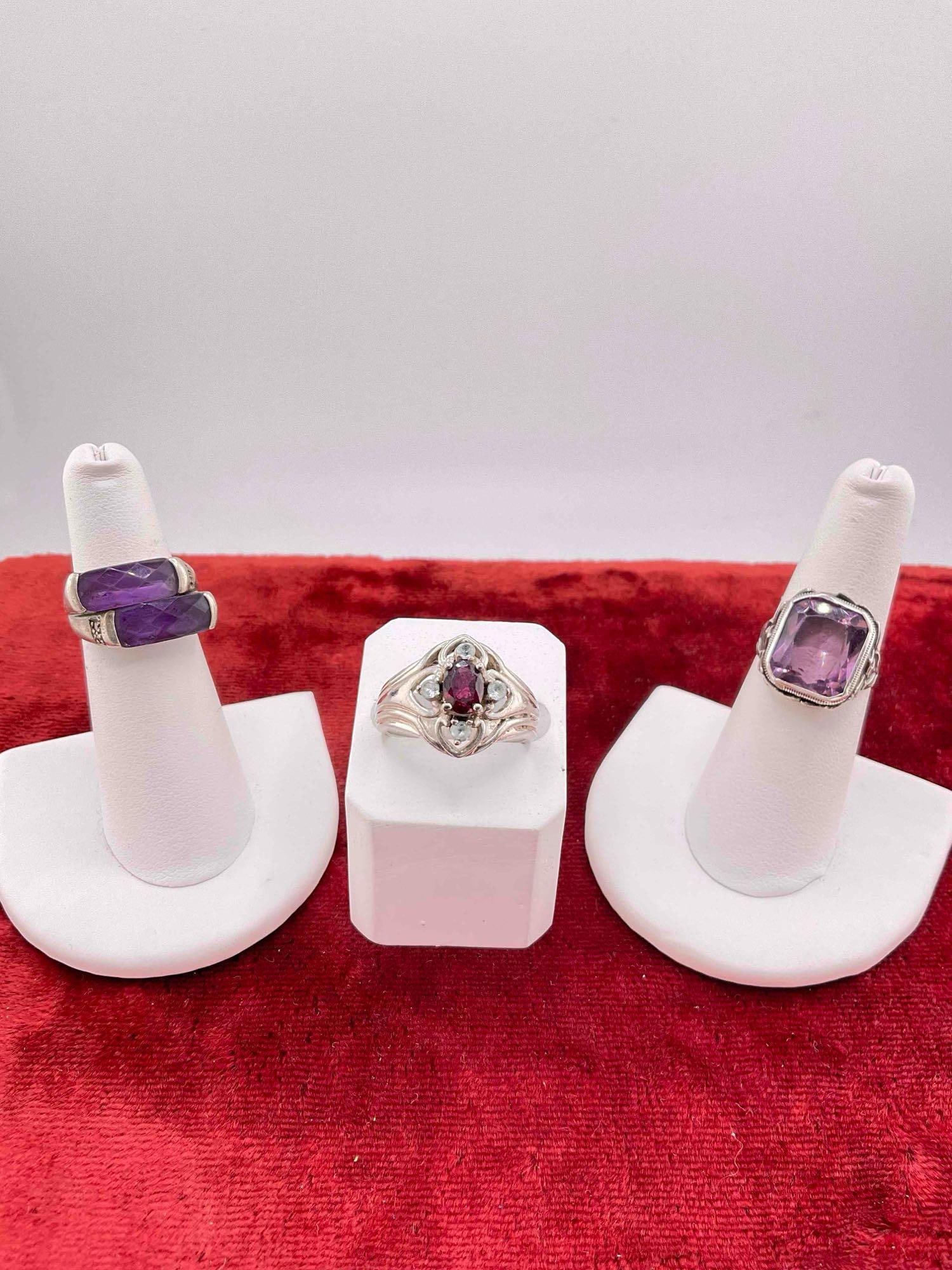 3 pcs Women's Fine Sterling Silver Rings w/ Amethyst/Garnet/Blue Topaz Toned Settings.: 3 pcs Women's Fine Sterling Silver Rings w/ Amethyst/Garnet/Blue Topaz Toned Settings. blue stones may be blue zircon toned. assorted sizes. weighs 17 grams. DM-1554
