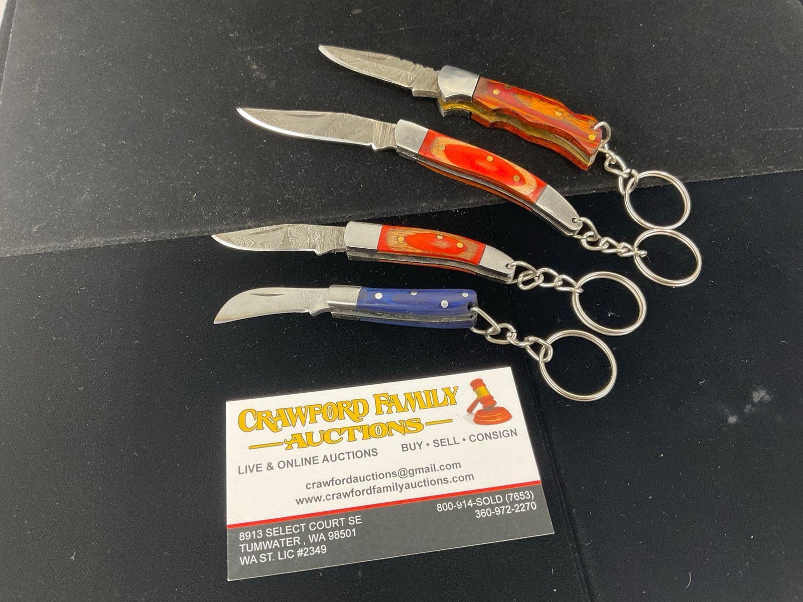 4 Keychain Folding Knives w/Tinted Wood Handles, Damascus 1 inch blades: All these knives are from the same collection. See pics for condition. Measures approx 5h x 4w x 5d inches. E-3440
