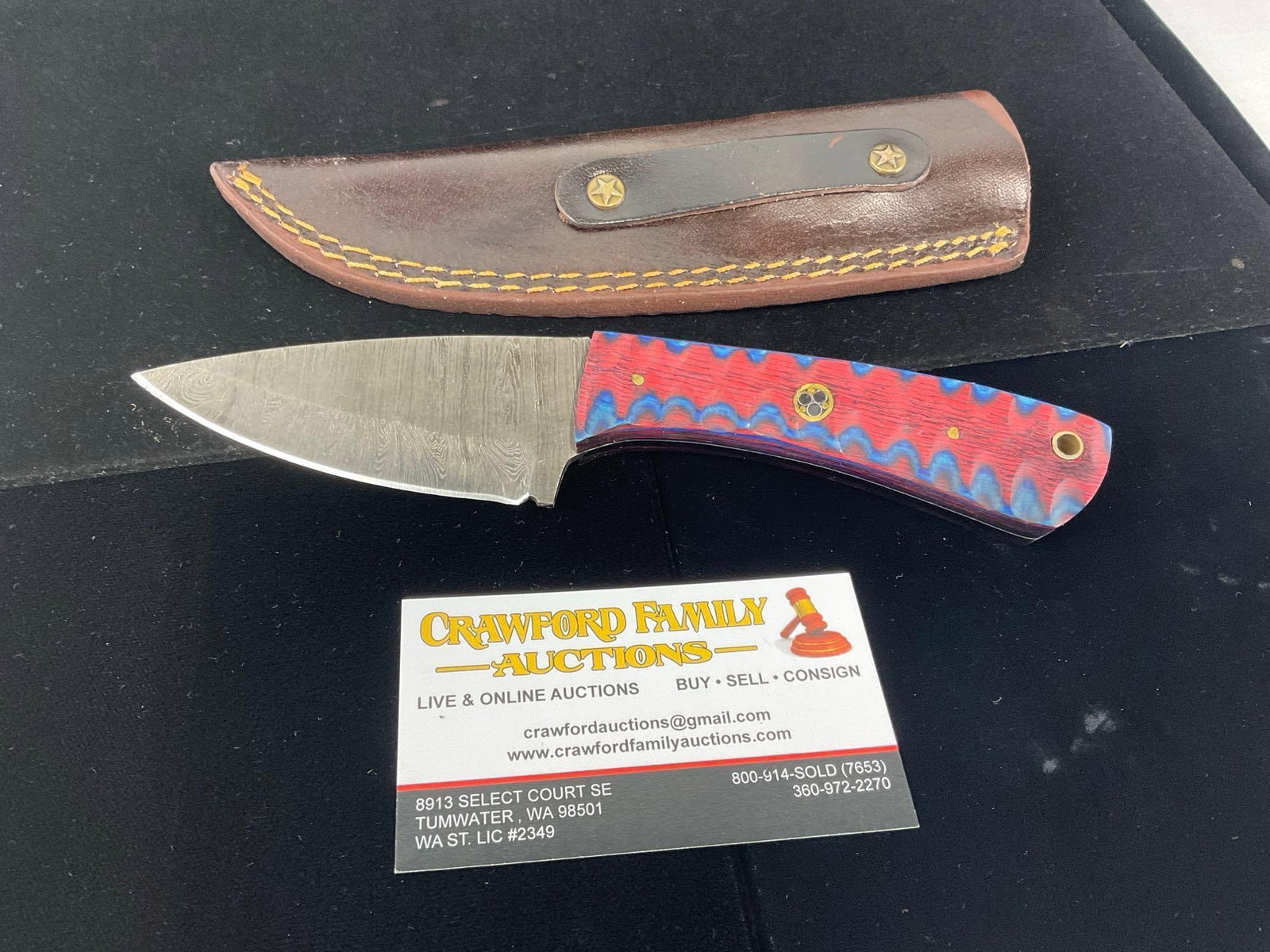 3 inch Damascus Knife w/Red & Blue Tinted Wood Handle & Leather Sheath: All these knives are from the same collection. See pics for condition. Blade measures approx 3 inches. Measures approx 10h x 3w x 2d inches. E-3440