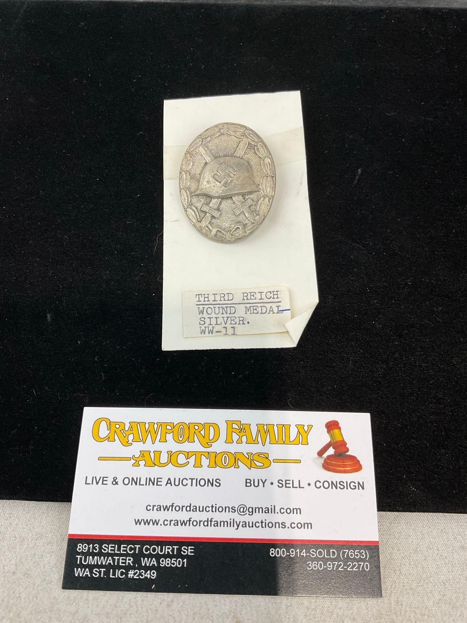 WWII Era circa 1939 Third Reich Wound Medal, Silvered, w/Swords, Helmet & Laurel Edge: Appears to be in good shape. The piece measures approx 5h x 3w x 2d inches. See pics. E-414