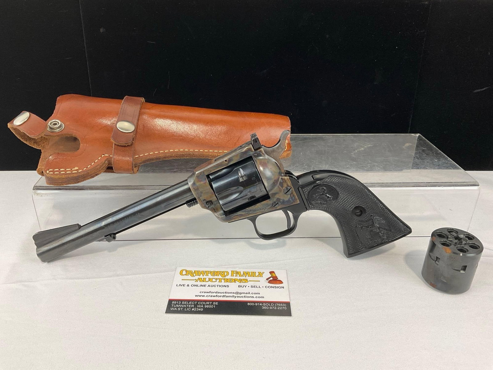 New Frontier Gate Loading Single Action Revolver w/.22 LR & .22 Mag cylinders, SN:L12005 FFL: With Leather holster. Appears to be in good shape. The piece measures approx 7h x 13w x 3d inches. The barrel measures approx 6 inches long. See pics. E-6600