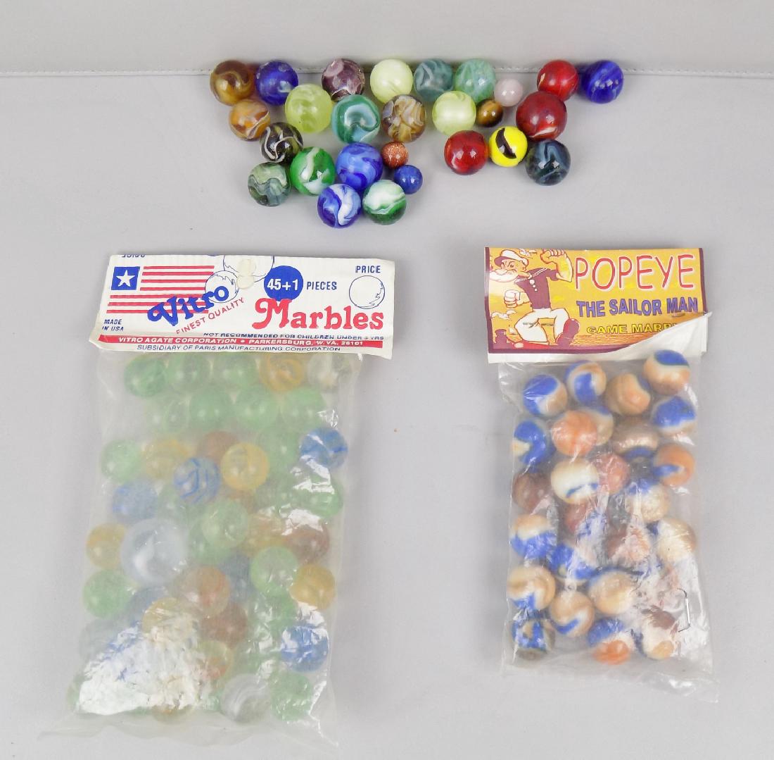 LOT OF MARBLES: A LOT OF ASSORTED MARBLES INCLUDING ONE BAG OF POPEYE THE SAILOR MAN AND ONE BAG OF VITRO MARBLES