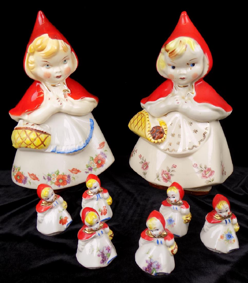 (2) HULL RED RIDING HOOD COOKIE JARS & 3 SETS SHAKERS: 2 STYLES OF COOKIE JARS, OPEN BASKET WITH GOLD STARS & CLOSED BASKET. PLUS 3 SETS OF SALT AND PEPPER SHAKERS SIGNED AS SHOWN. MEASURE ABOUT 13" HIGH AND SHAKERS ARE 3-1/2" HIGH