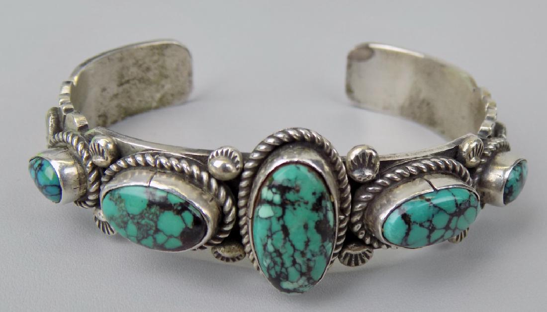 S-WESTERN STERLING BRACELET, 5 OVAL TURQUOISE STONES: SIGNED J. JOHNSON & STERLING, SIZE 7", 3/4" WIDE.