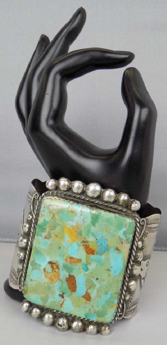 S-WESTERN STERL. LG SQ. GREEN TURQUOISE CUFF BRACELET: SIGNED A.J.C. (ALBERT & JEANETTE CLEVELAND, NAVAJO, BEAUTIFUL GREEN TURQUOISE, HOWLING COYOTES ON EACH SIDE, SIZE 7", 3" WIDE.