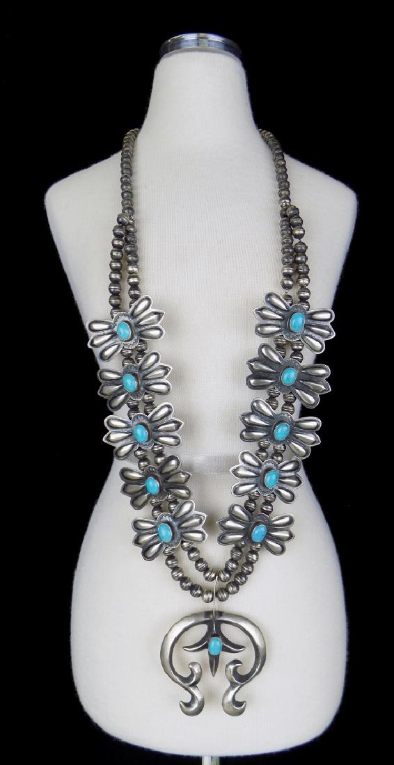 S-WESTERN STERL. & TURQ. SQUASH BLOSSOM NECKLACE: SIGNED STERLING & RJ (ROBERT JOHNSON, NAVAJO), 25" LONG. NOTE DISPLAYED ON MINIATURE MANNEQUIN, SEE ACTUAL SIZE