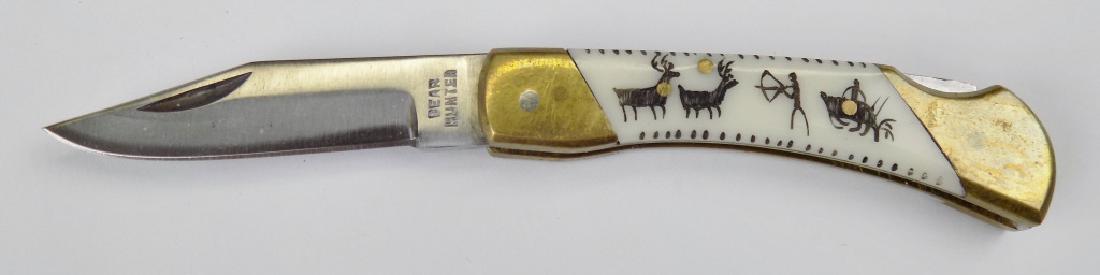 SOLIGEN DEER HUNT LOCKBACK FOLDING KNIFE: "BEAR HUNTER" STAINLESS, HAND CARVED SCRIMSHAW STYLE CARVED HANDLE OF DEER HUNT. 3" CLOSED, 5-1/4" OPEN.